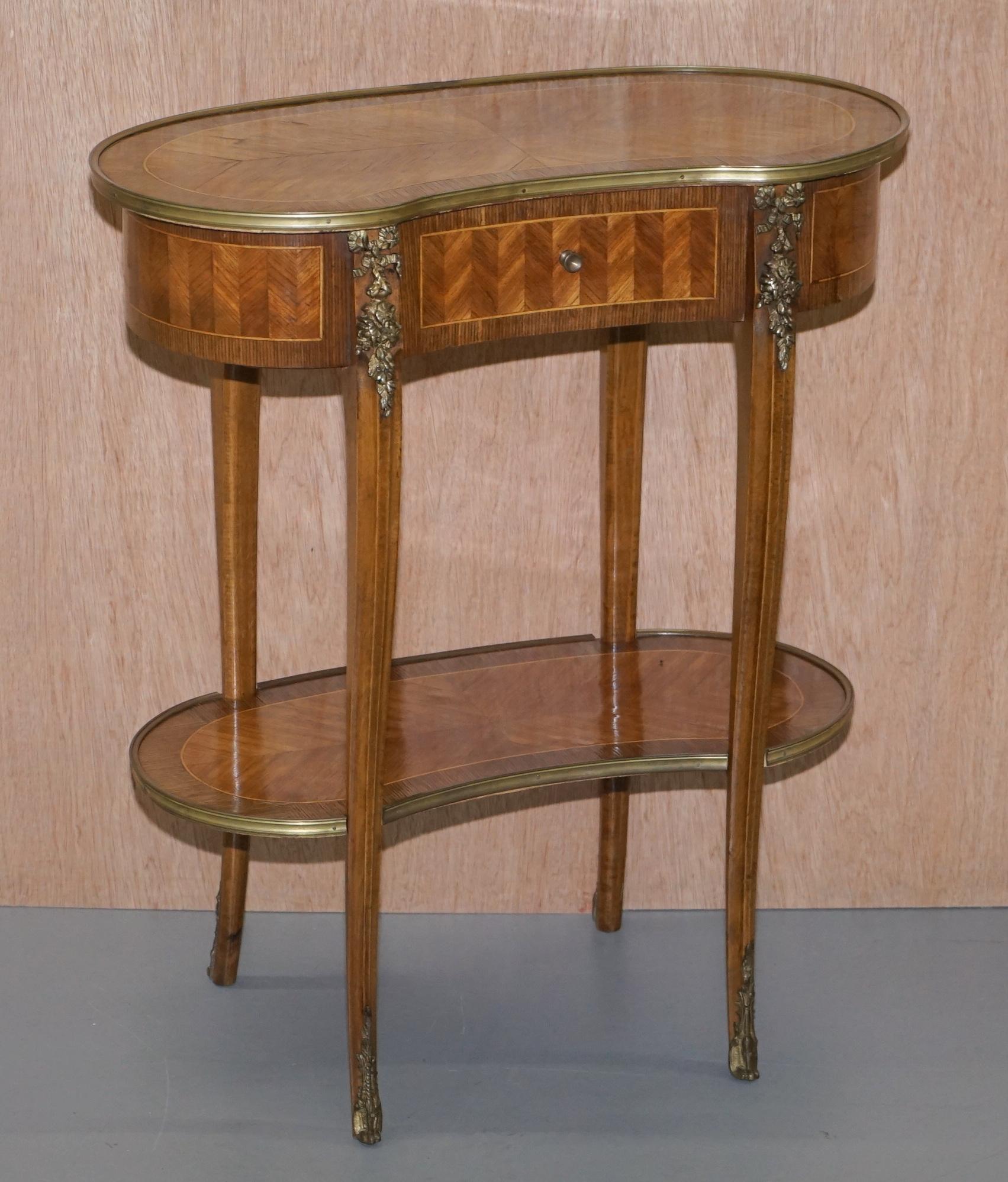 We are delighted to offer for sale this lovely pair of Louis XVI style kidney shaped side tables with bronzed fittings

A very good looking and well made pair, the fixtures and fittings are all bronzed, the tables are inlaid with mahogany and