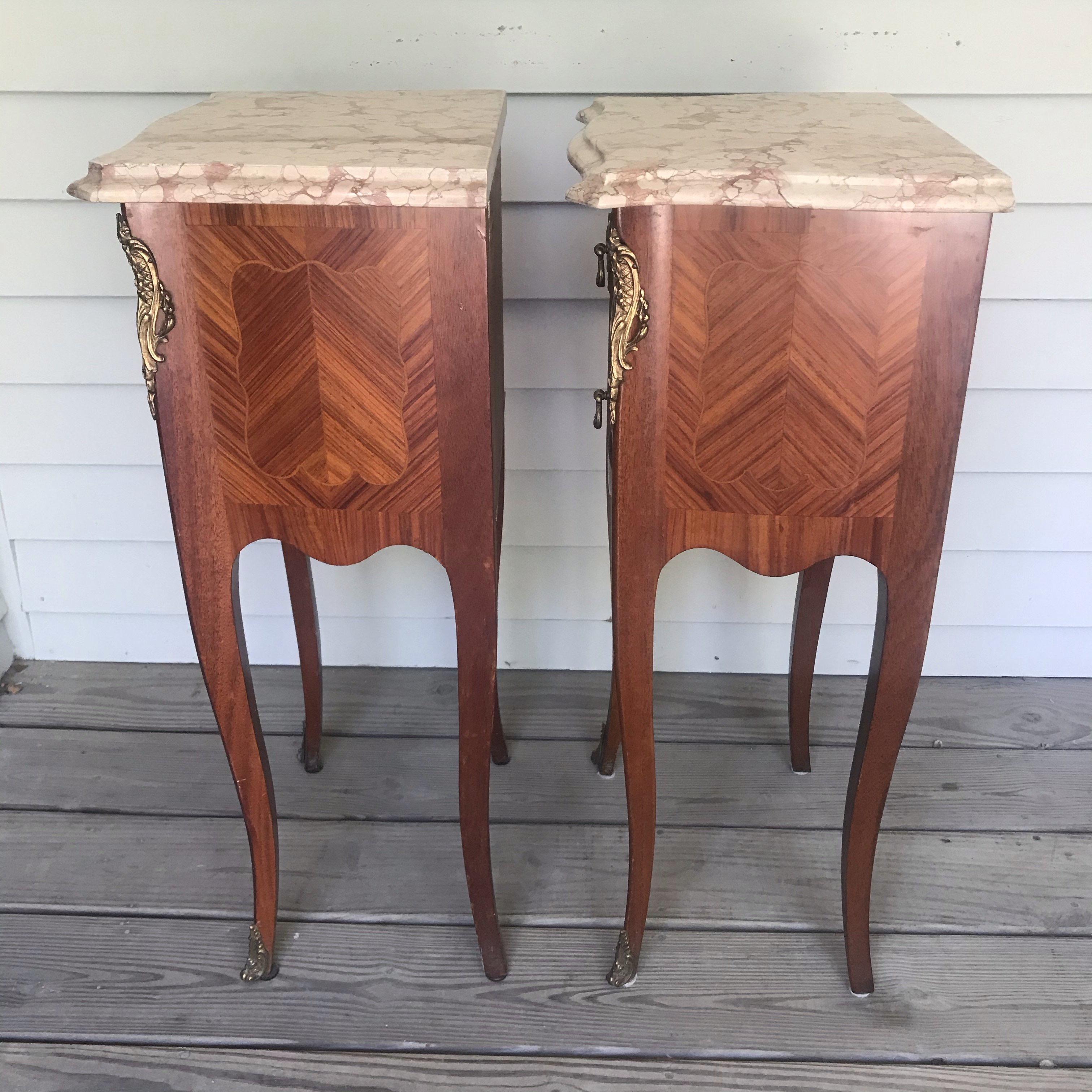 Pair of lovely inlaid French antique marble top nightstands from Lyon, France. Good quality 20th century Louis revival; very handsome - each with 2 drawers with brass handles and pretty embellishments on the edges.

#4838.
  