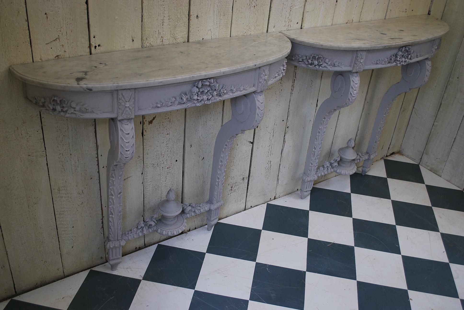 An unusual pair of French console tables with original Carrera marble tops. Decorated in grey paint of foliage and classical motifs.
Pairs of decorative consoles are always hard to find and these are a nice example.