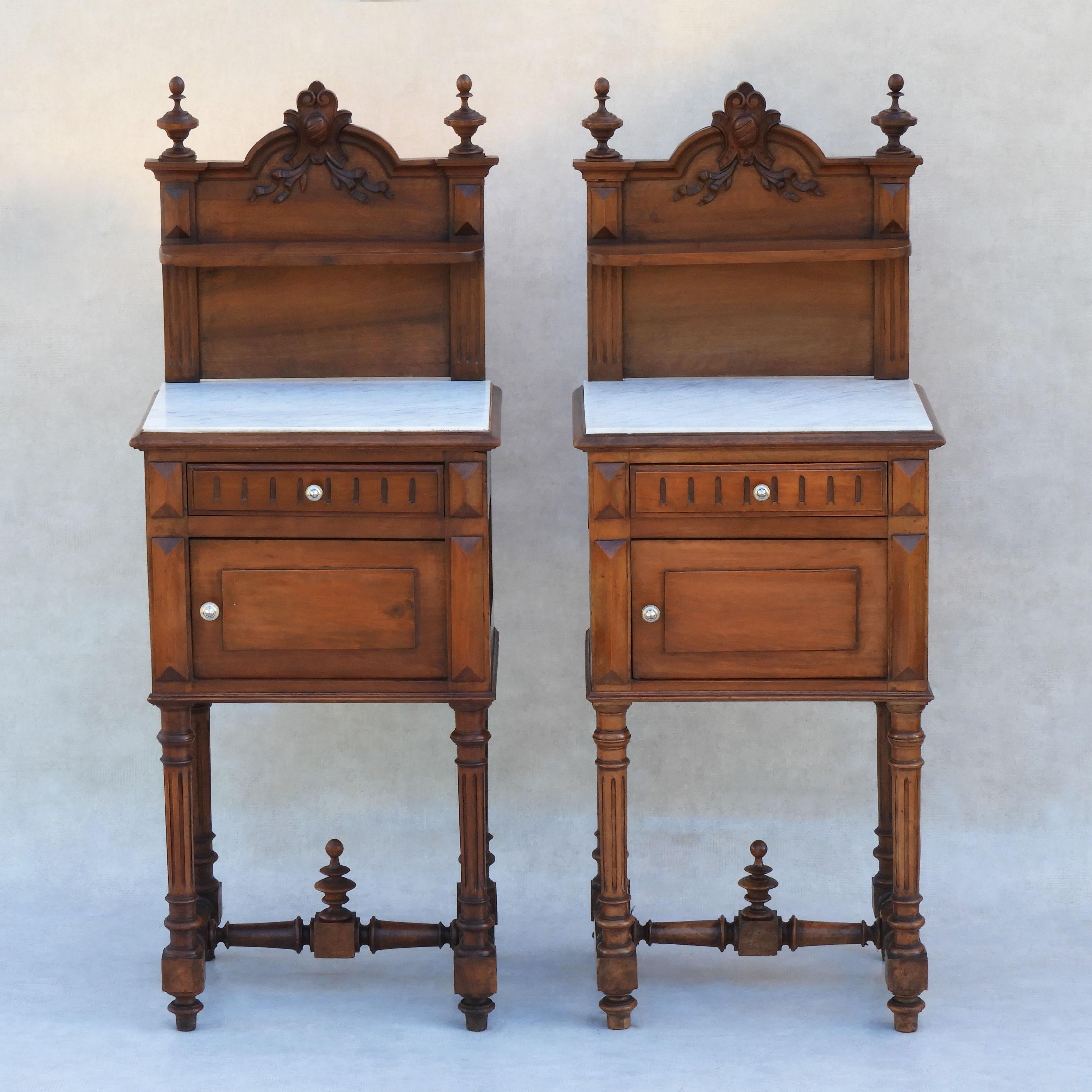 Pair of French antique night stands in walnut and marble C1890

A fabulous pair of Antique bedside cabinets or night stands from 19th century France. 

Two solid walnut cabinets each with a marble top, shelf, drawer and ceramic lined cupboard. Tall,