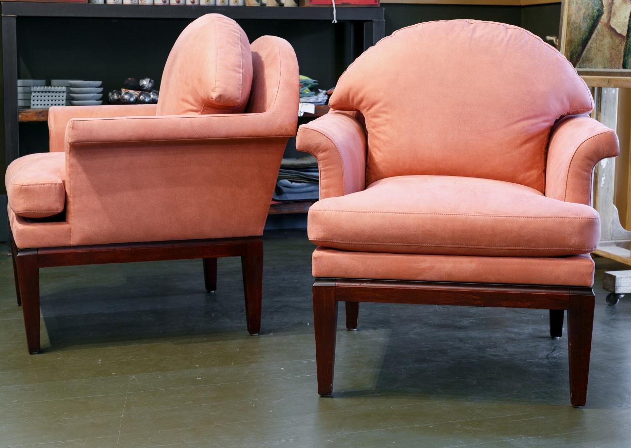 This pair of chairs was produced and designed by Jacques Coulon for a Paris hotel. They have been re-upholstered in a salmon-colored ultra-suede. They are of Classic Mid-Century Modern design and look fresh today. The frame is solid wood. I might