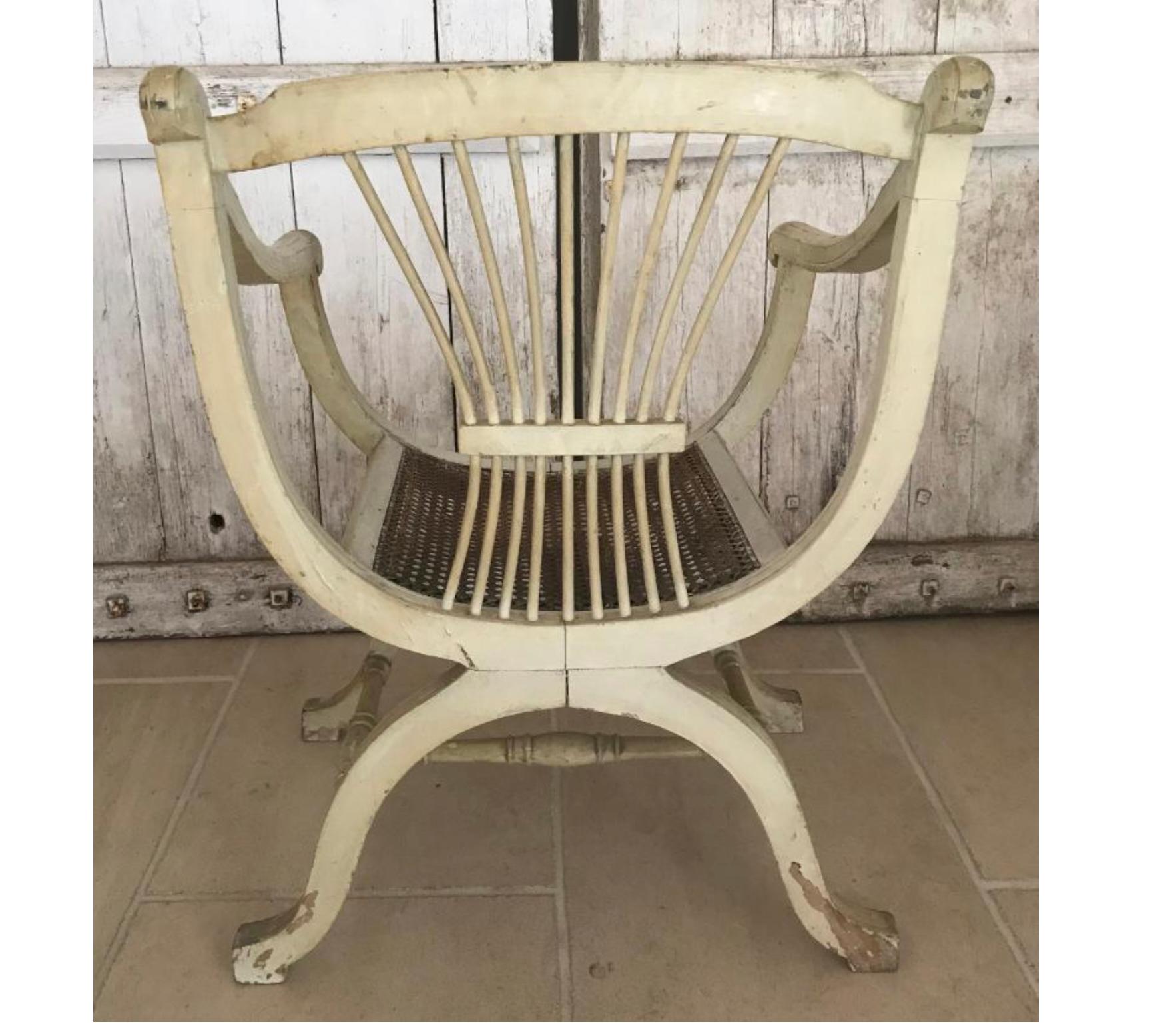 Unusual Late 1800s early 1900s French antique pair of armchairs in original white paint with carved backs and beautiful curved arms and legs. They hark back to Napoleon's favorite Empire style and are very delicate to look at.

Canework seats
