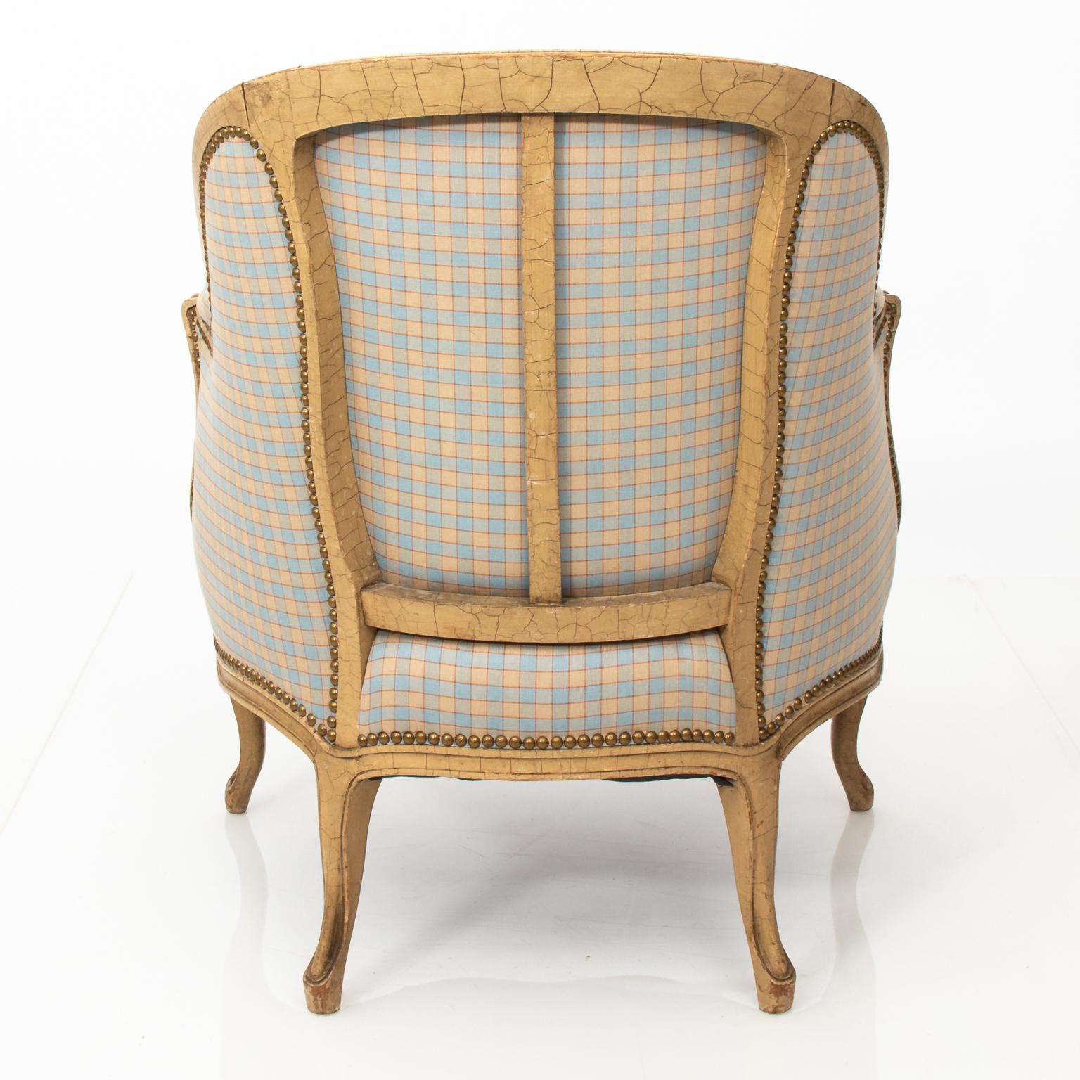 Pair of French style upholstered curved back armchairs in a check fabric with the frame in a crackled finish.