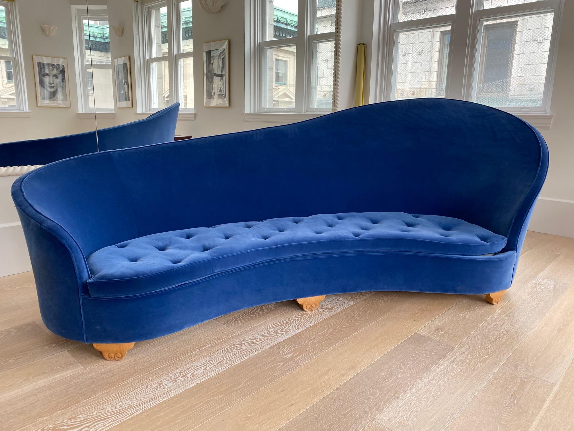 Pair of French Art Deco 1930s blue velvet kidney shaped sofa's resting on sycamore carved feet.
This is a true pair of sofa's, one is the mirror image of the other.