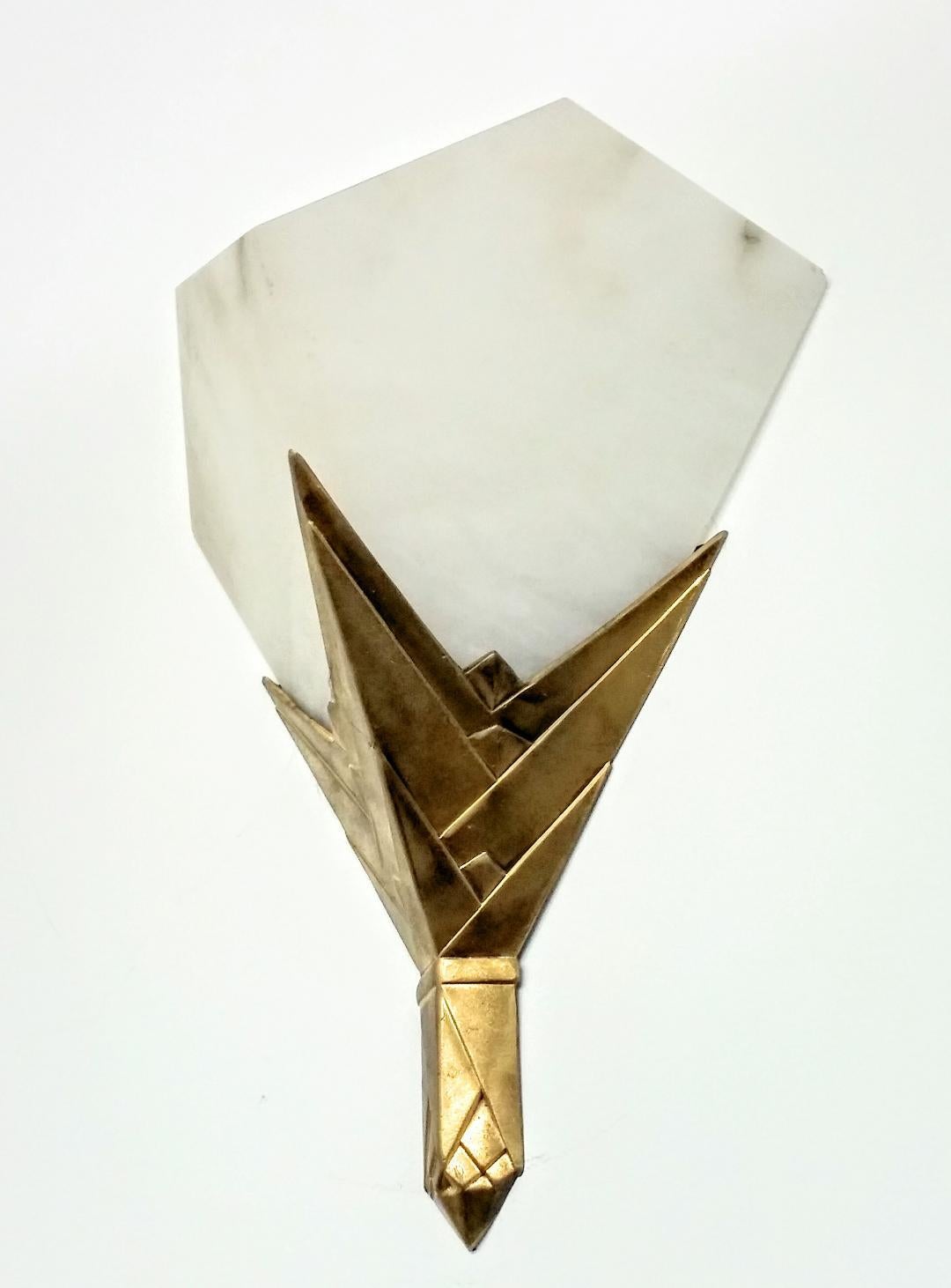 A pair of French Art Deco Alabaster sconces. Both alabaster shades and bronze frames are in a geometric streamlined design. Each sconce has been re-wired to the U.S. standards with one candelabra socket. (60 Watt max.) Two pairs are available.