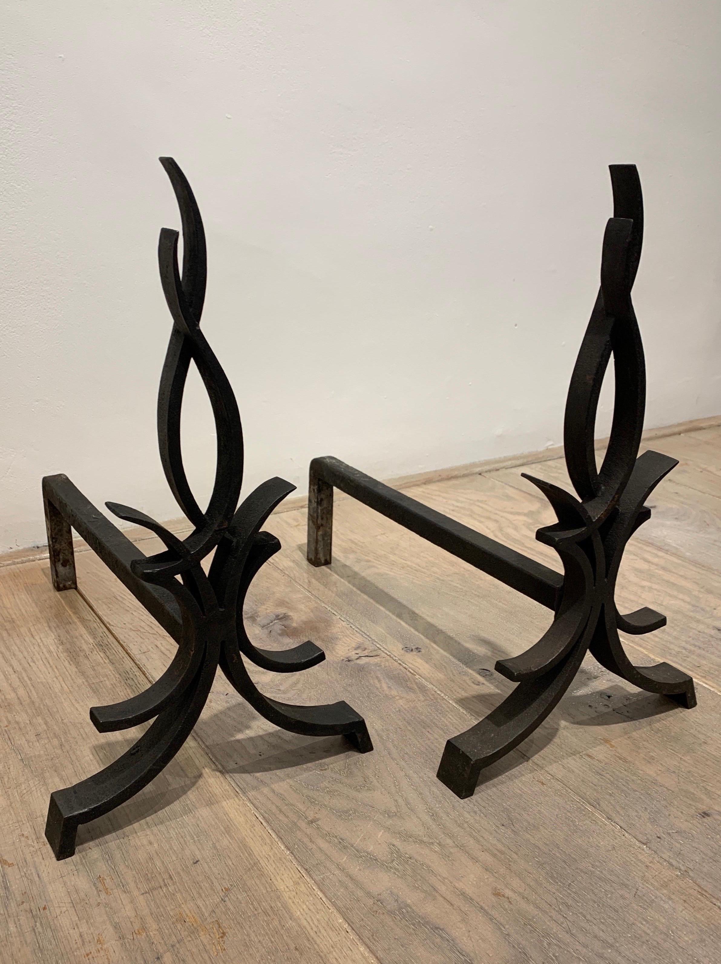 The present pair is made of wrought iron. It represents a stylised flame in the style of the famous Art Deco wrought Iron master Raymond Subes.