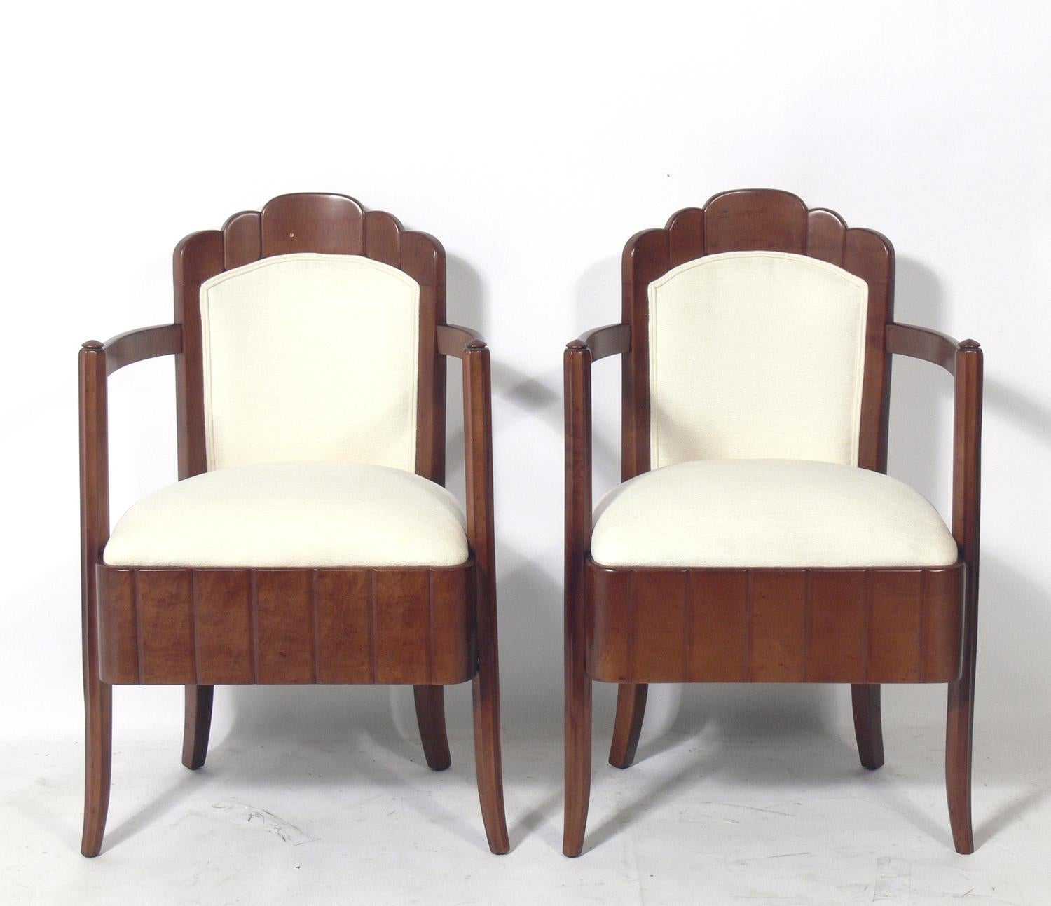 Pair of Art Deco armchairs, designed by Pierre Patout, for the Ile de France ocean liner, French, circa 1930s. They have been completely restored. Refinished in their original color and reupholstered in an ivory bouclé fabric.