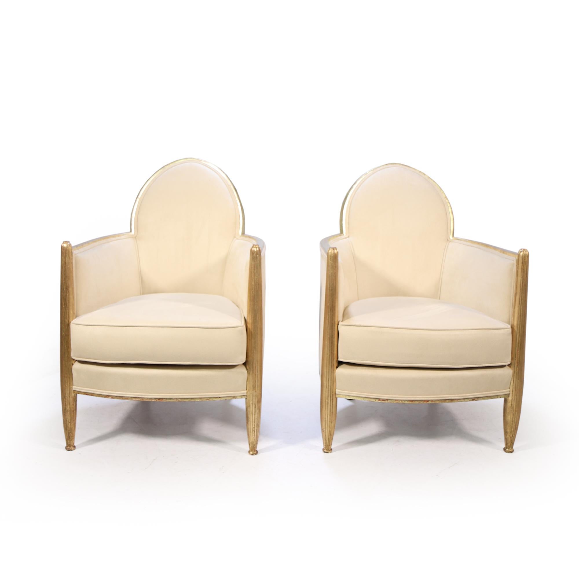A fine quality parcel gilt shield back pair of armchairs, with two toned gilding the turned and fluted legs are gold leaf and the frame is white gold, this has 70% of original gilding and we have had it carefully matched in keeping the patina to the