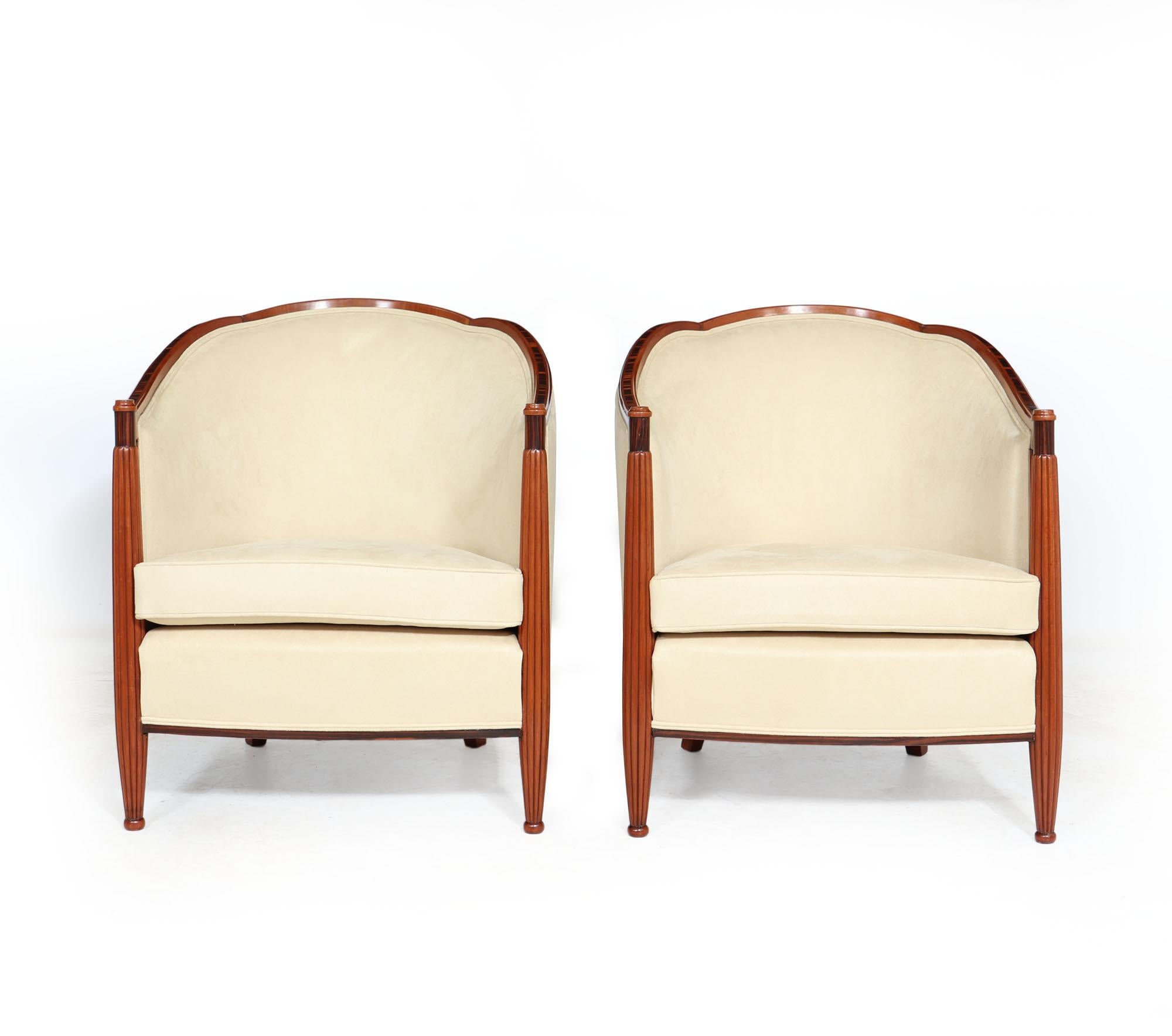 A pair of French Art Deco armchairs with reeded front legs tri lobe-shaped top and macassar ebony detail at the top of the front leg and around the base of the chair. These chairs have been stripped down to the frame and fully polished then fully