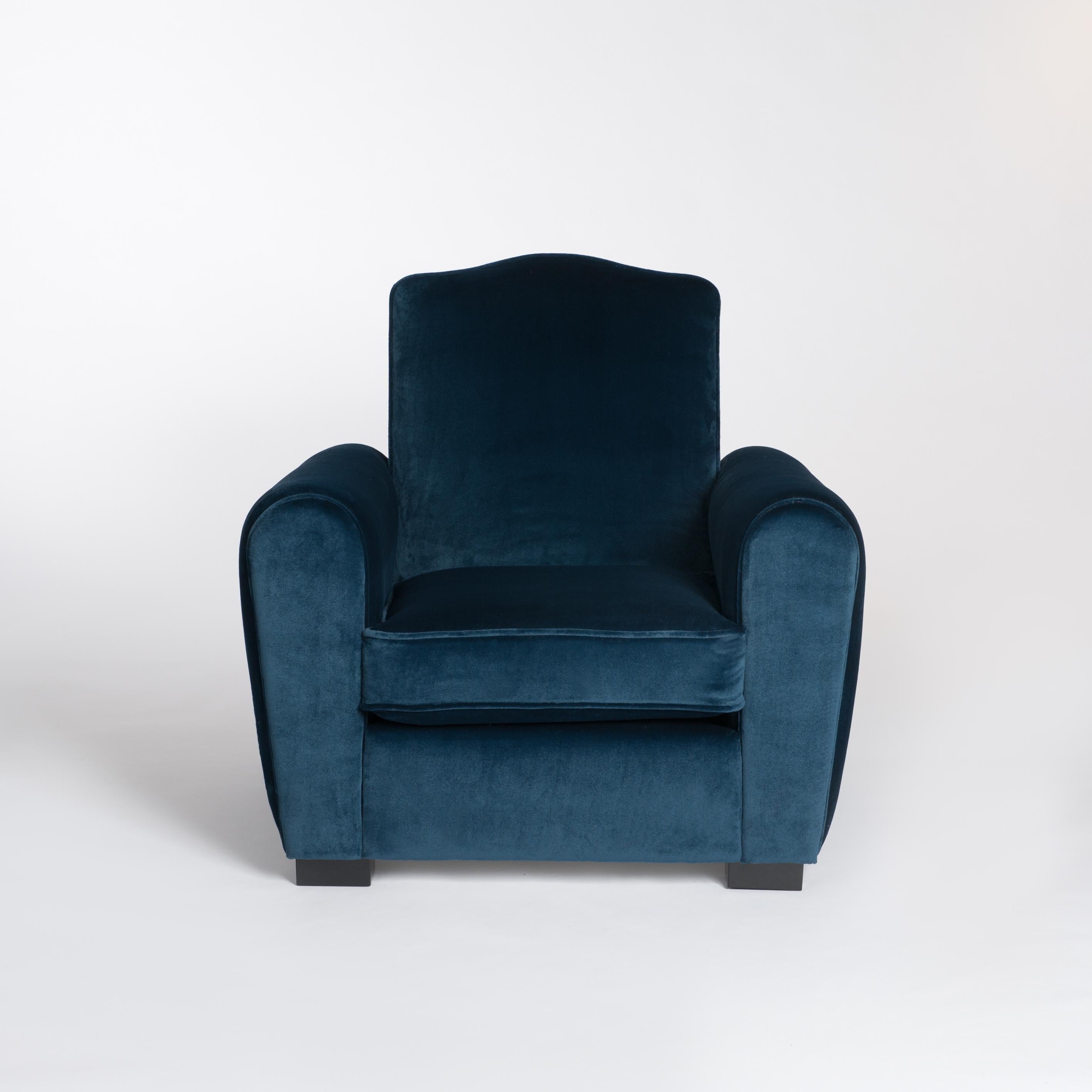 A pair of large French Art Deco club chairs in turquois-blue velvet from Rubelli.
Classic Moustache style back and two separate seat cushions. Full restoration and update inside and outside of the chairs.
The wooden foot parts are black lacquered.
 