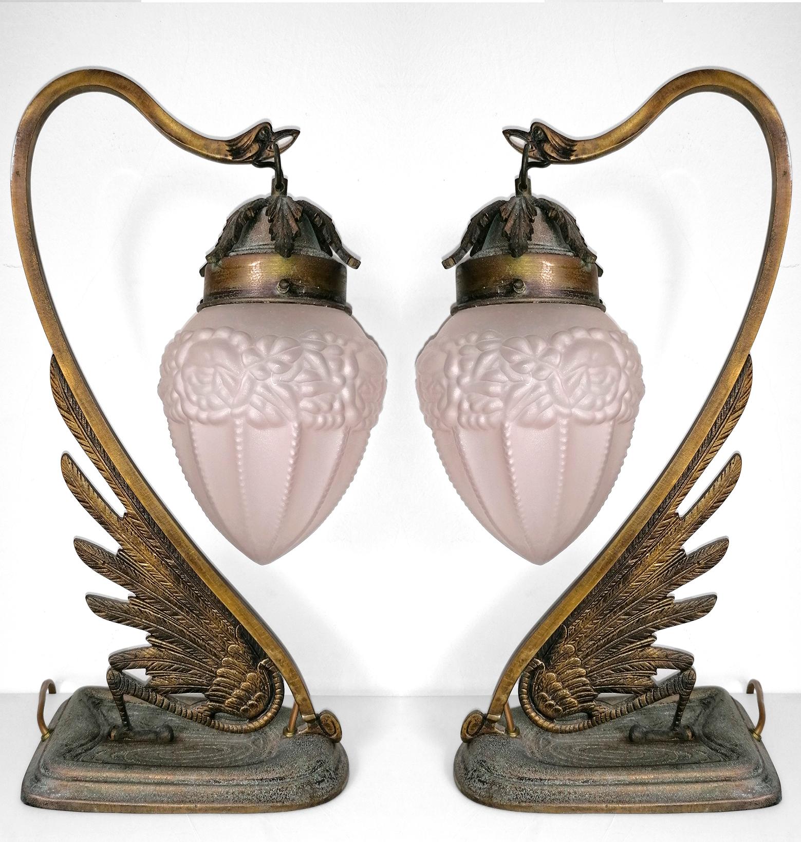 Gorgeous pair of antique French Art Nouveau and Art Deco table lamps. Ornate engraved bronze and frosted pale pink satin glass flower lamp shades.
Dimensions
Height: 16.54 in. (42 cm)
Width: 9.85 in. (25 cm)
Depth: 5.91 in. (15 cm)
Age