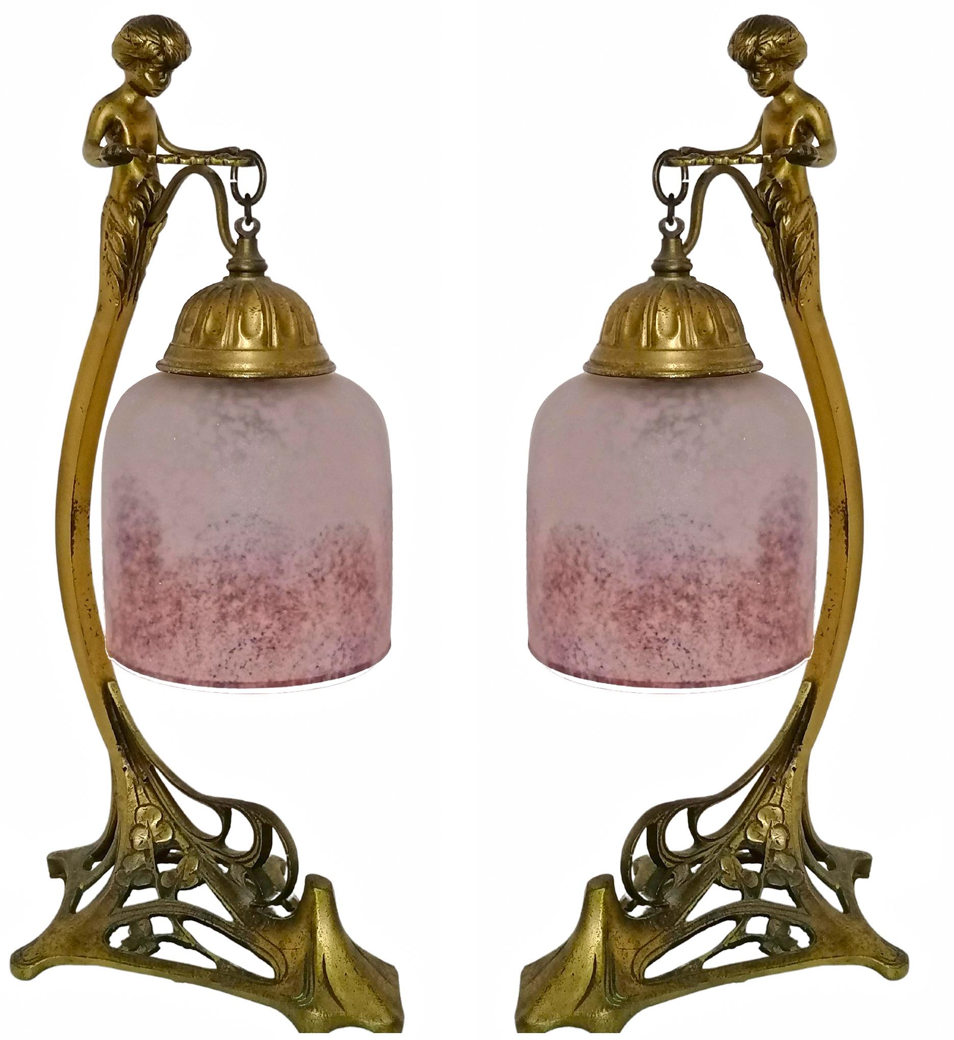 Gorgeous pair of antique French Art Nouveau and Art Deco table lamps. Ornate engraved bronze and frosted pink art glass lamp shades.
Dimensions
Height: 15.36 in. (39 cm)
Width: 5.91 in. (15 cm)
Depth: 8.27 in. (21 cm)
Age patina
2-light bulbs