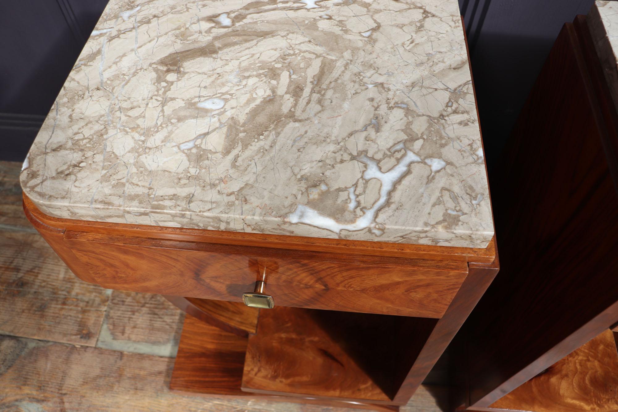 Art Deco bedside tables
Pair of beautiful French Art Deco walnut bedside tables, having geometric form with half u shape to one side, single drawer marble tops all standing on an ornate base as you can see the they are great quality and in