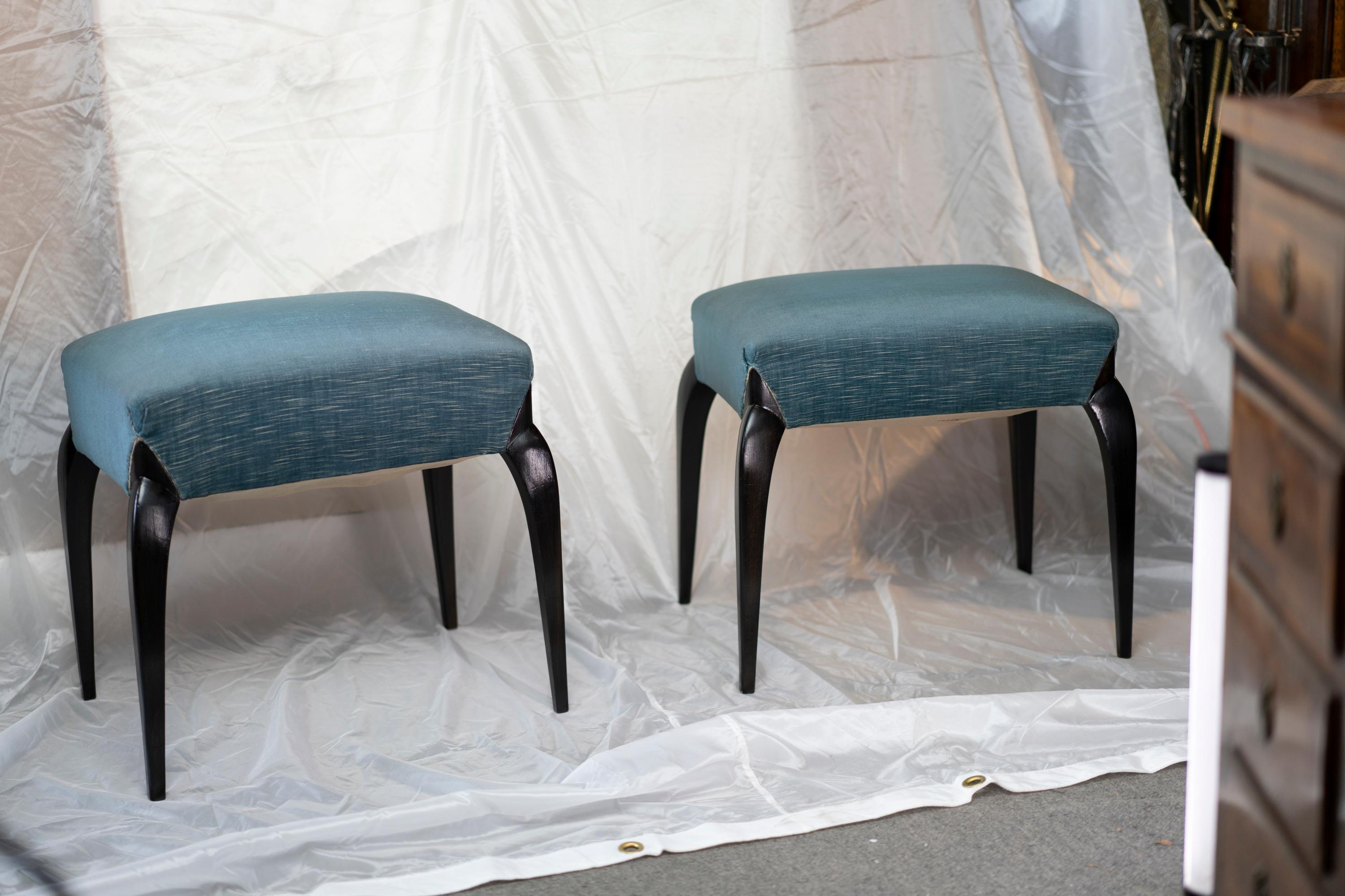 Elegant pair of French Art Deco period ebonized  beechwood stools upholstered with blue fabric upholstered .