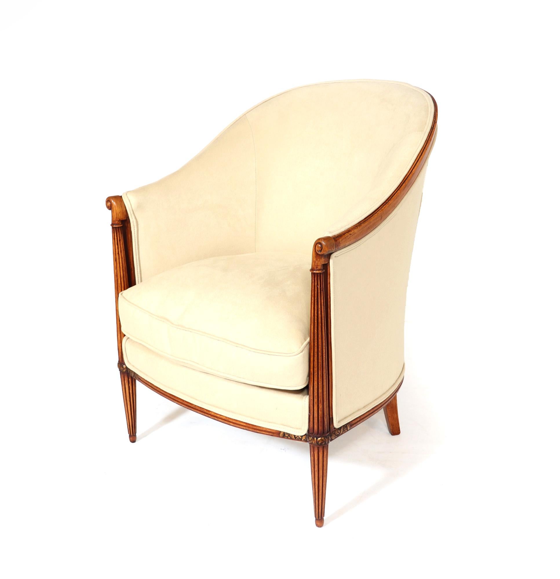 A fine quality pair of French art Deco bergeres with turned reeded leg with shaped top and gilded carving polished show wood and fully upholstered, coil sprung with down filled cushion and covered in soft cream velvety suede type fabric that is