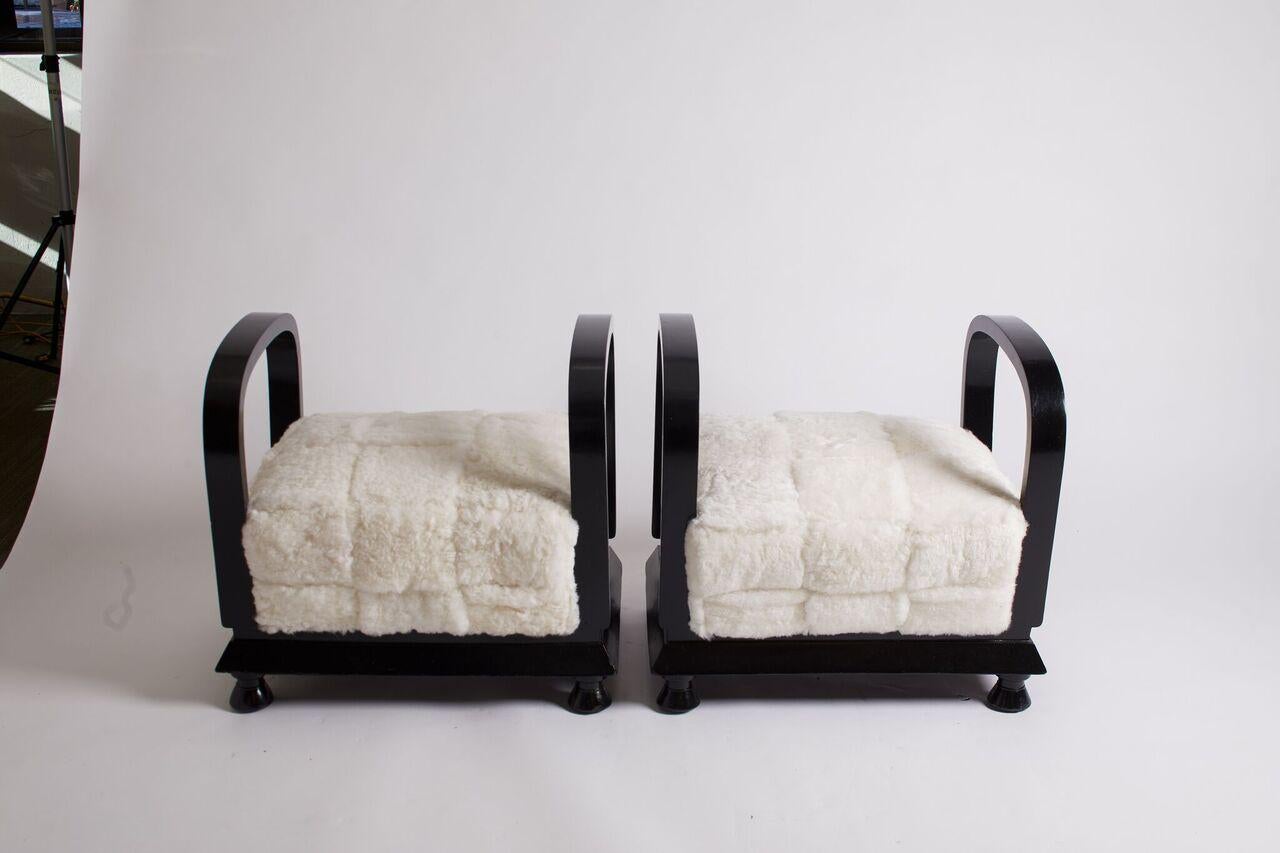 Pair of fully restored French Art Deco benches with black lacquer arms and base and white sheepskin seat, circa 1930s.