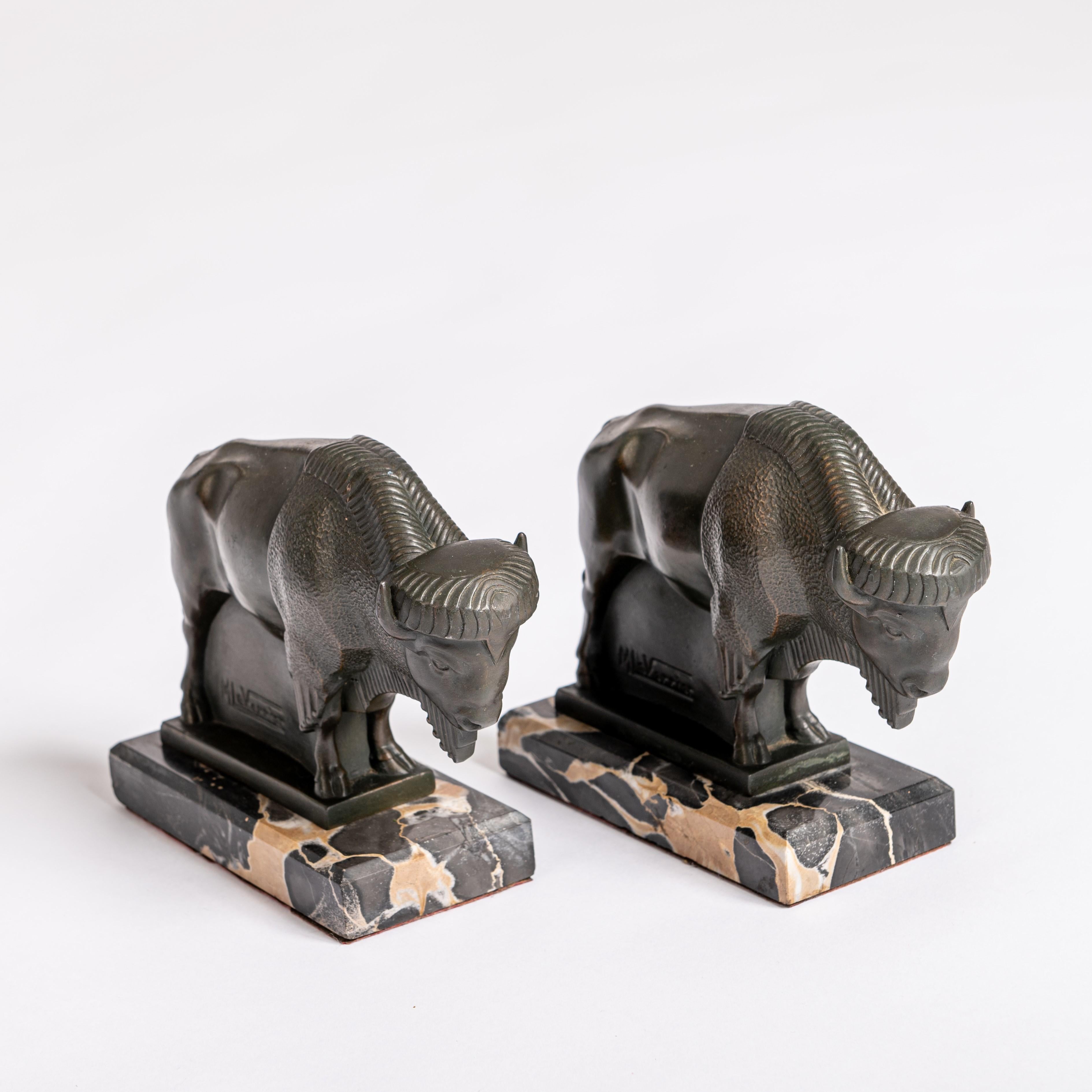 Extremely decorative and very finely designed cubic Art Deco bookends by Max Le Verrier.
Clear and strict depiction of bison in green bronze on a black and cream colored marble base.

Louis Octave Maxime Le Verrier, short Max Le Verrier (born