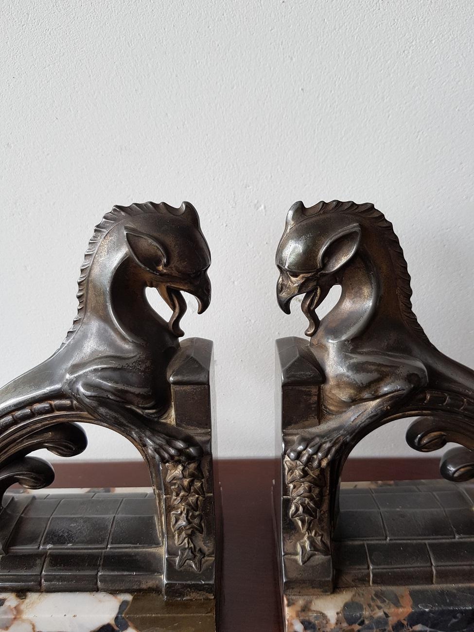 Set of two fabulous French Art Deco bookends depicting mythical creatures on marble base and both have an old silverplated patina, circa 1930.

The measurements are,
Depth 8 cm/ 3.1 inch.
Width 15 cm/ 5.9 inch.
Height 17 cm/ 6.6 inch.
 