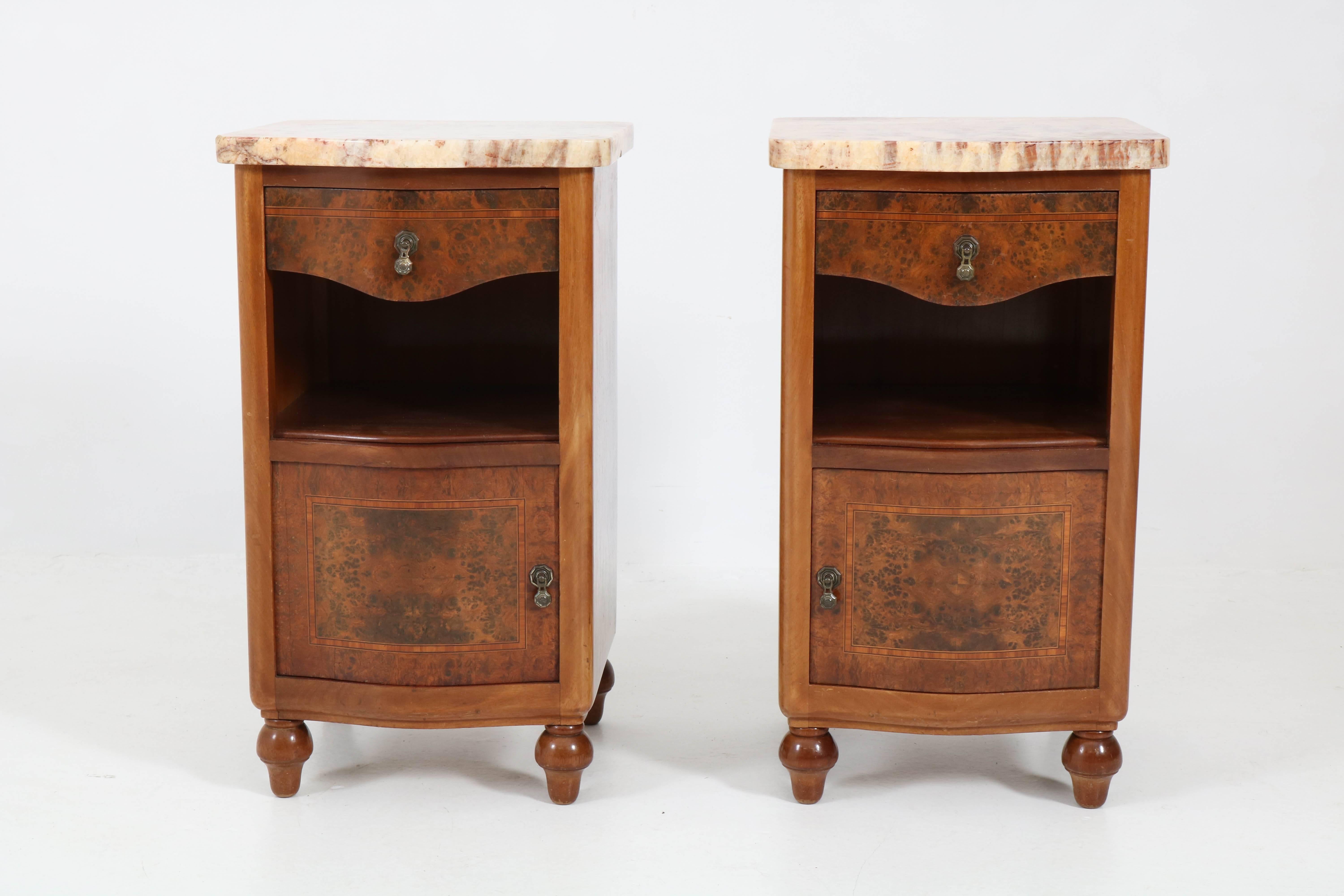 Stunning pair of French Art Deco nightstands or bedside tables, 1930s.
Burl walnut with inlay.
Original colored marble tops.
In good original condition with minor wear consistent with age and use,
preserving a beautiful patina.