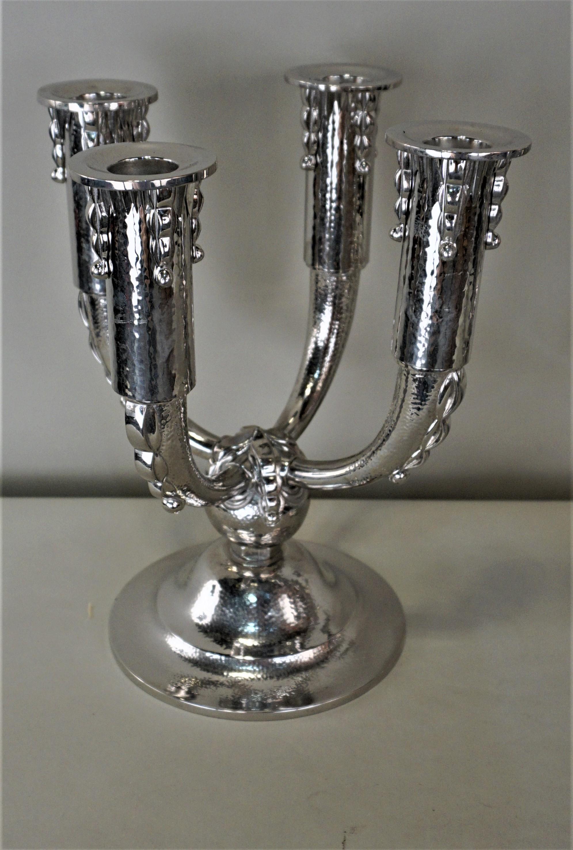 Pair of 1920s hammered design nickel on bronze four arm candelabra.