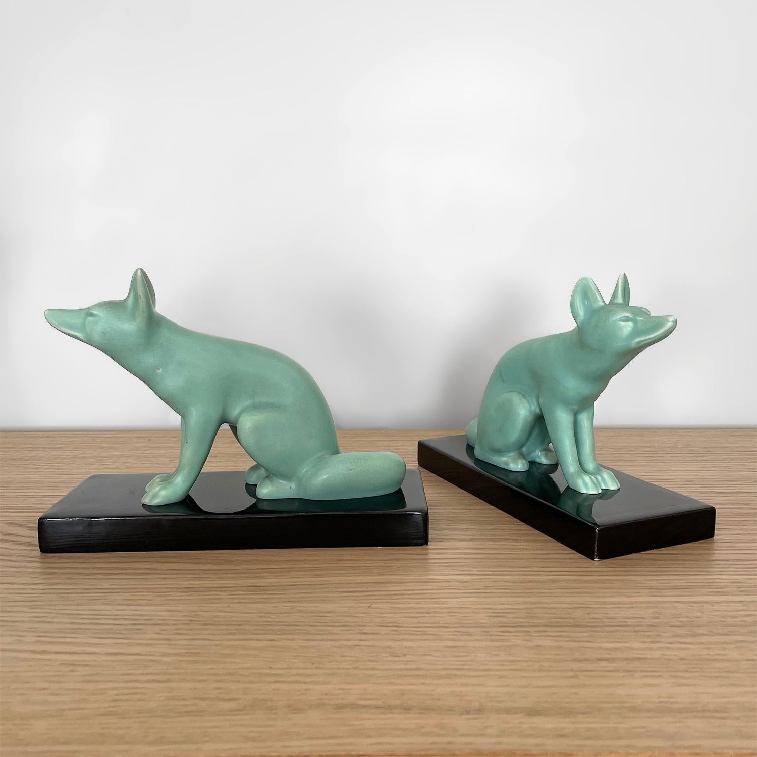 Pair of French Art Deco fox bookends
France, circa 1940’s
Matte finished celadon earthenware foxes
Glazed sandstone bases
Minor glazing imperfections (please reference photos)
Beautifully preserved
Patina from age and use
Priced and sold as a pair