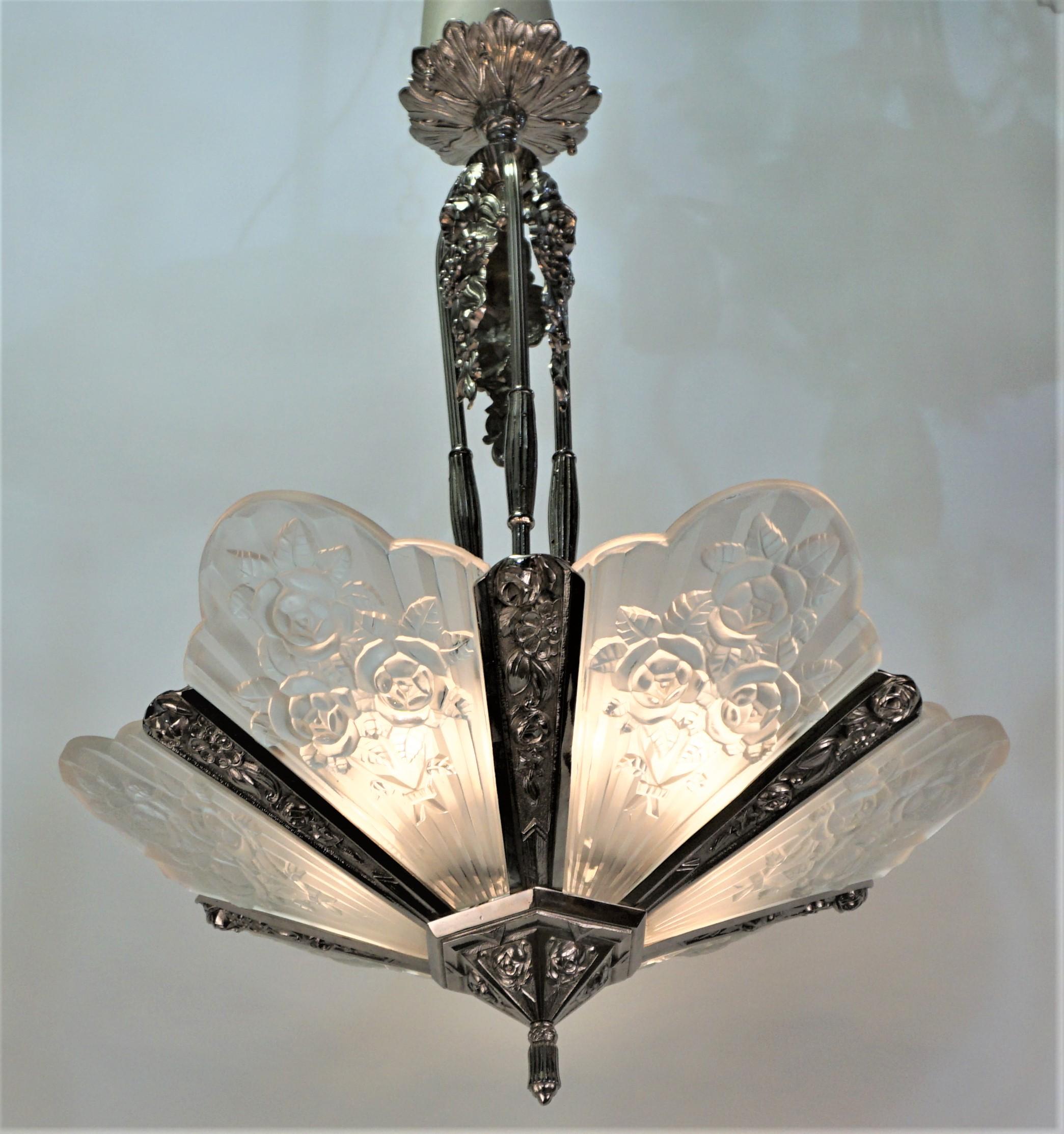 Clear Frost glass polished nickel on bronze 1930s Art Deco chandeliers.
Twelve lights 60 watt max each.