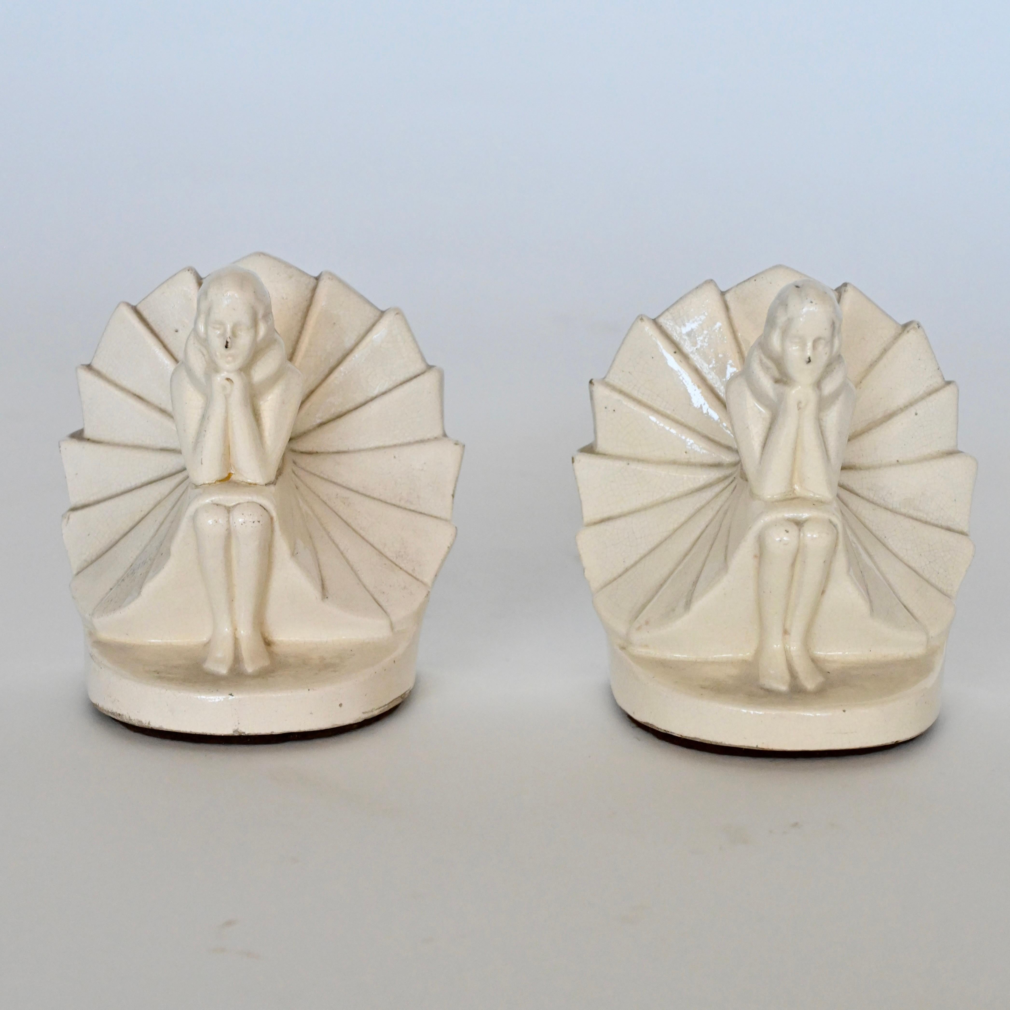 Pair of Art Deco craquelé bookends in the form of sitting ladies. Designer unknown. France, circa 1930's.
