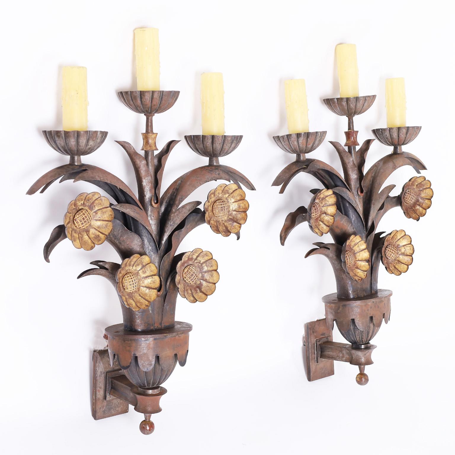 Pair of French three light wall sconces crafted in steel and iron in a floral motif exploring early art deco influences mixed with industrial architecture, probably designed for a specific building.