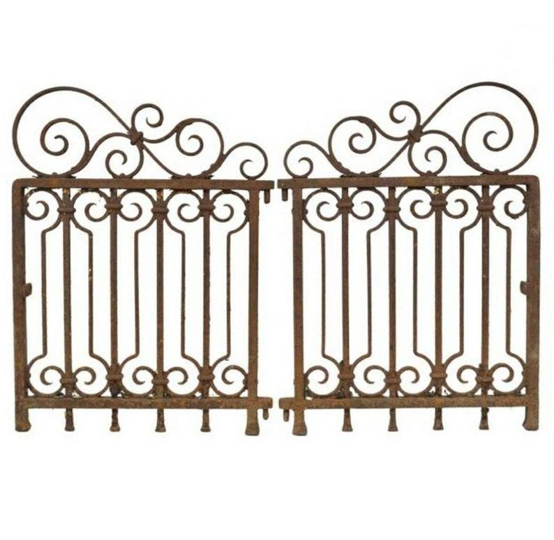 A pair of period, Art Deco styled hand forged wrought iron garden gates. Circa 1910-1920

Born in France in the early 20th century, the magnificent original matched pair of architectural salvaged building elements feature a fabulous, uniquely