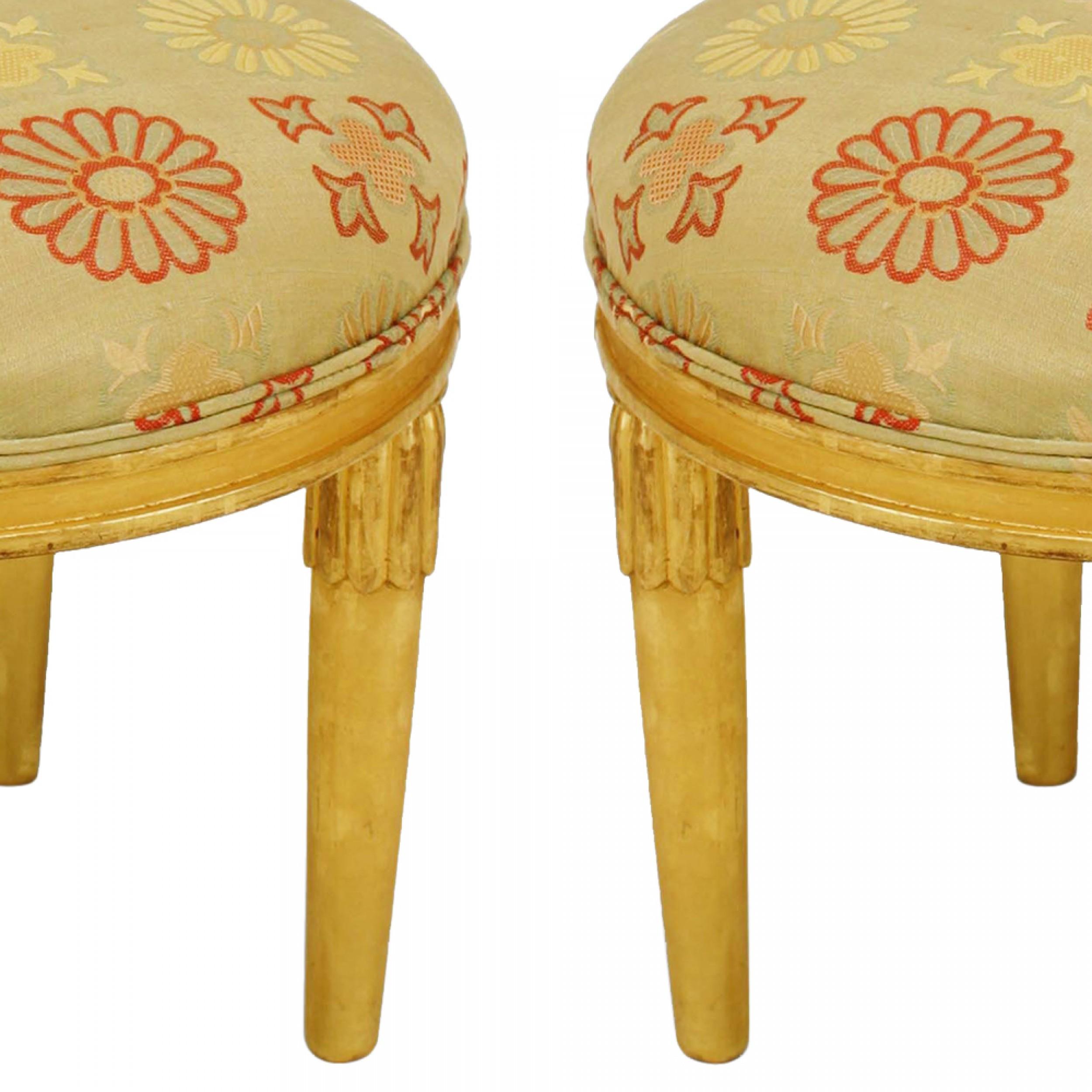 Pair of French Art Deco gilt round low stool with four round tapered legs having a stylized fluted top and upholstered seat (attributed: Sue et Mare).
 