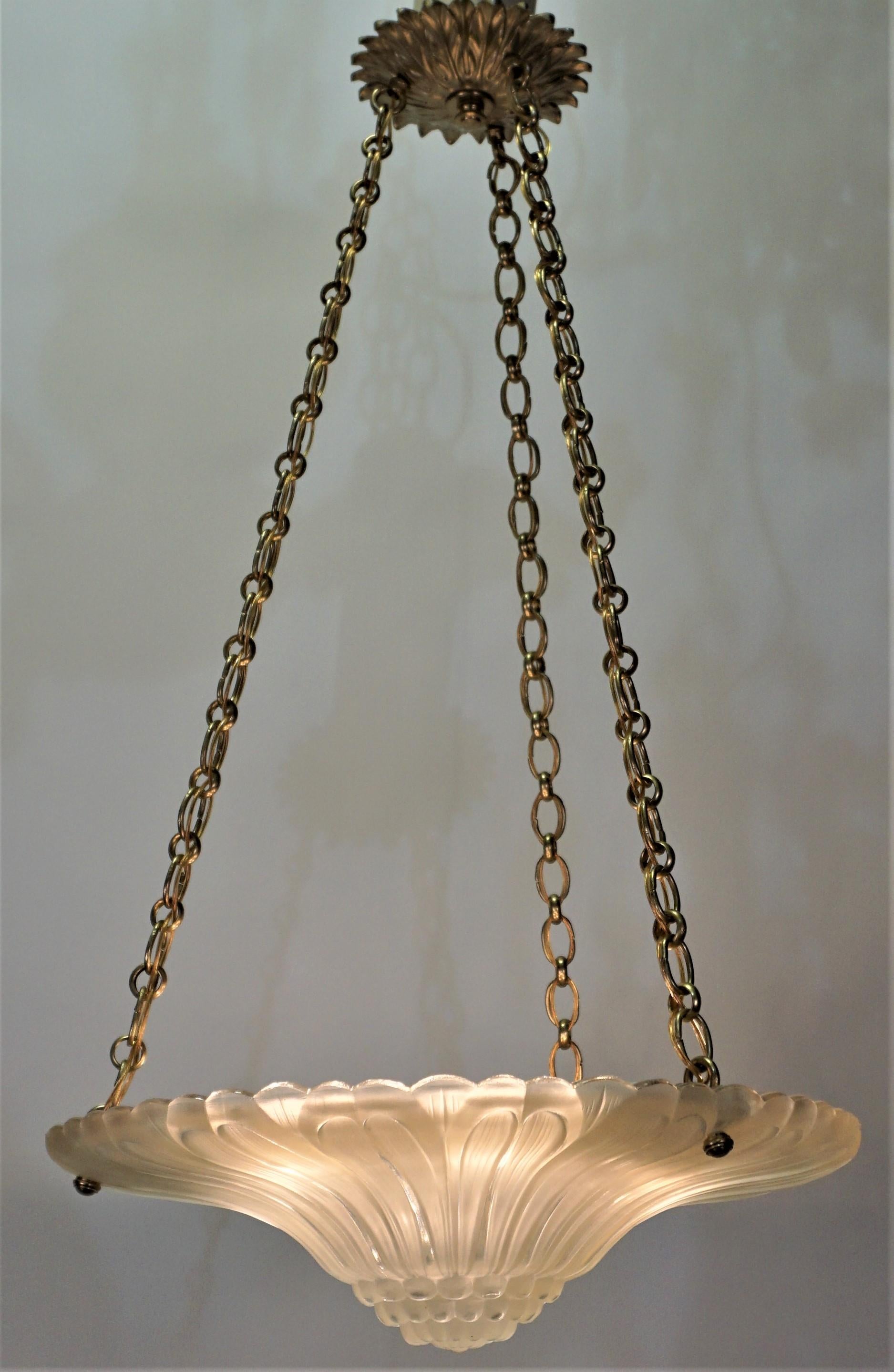 An elegant clear Frost glass with bronze mounting Art Deco chandelier.
Six lights 60 watts each max.
Height can be adjusted by removing some of the chain.