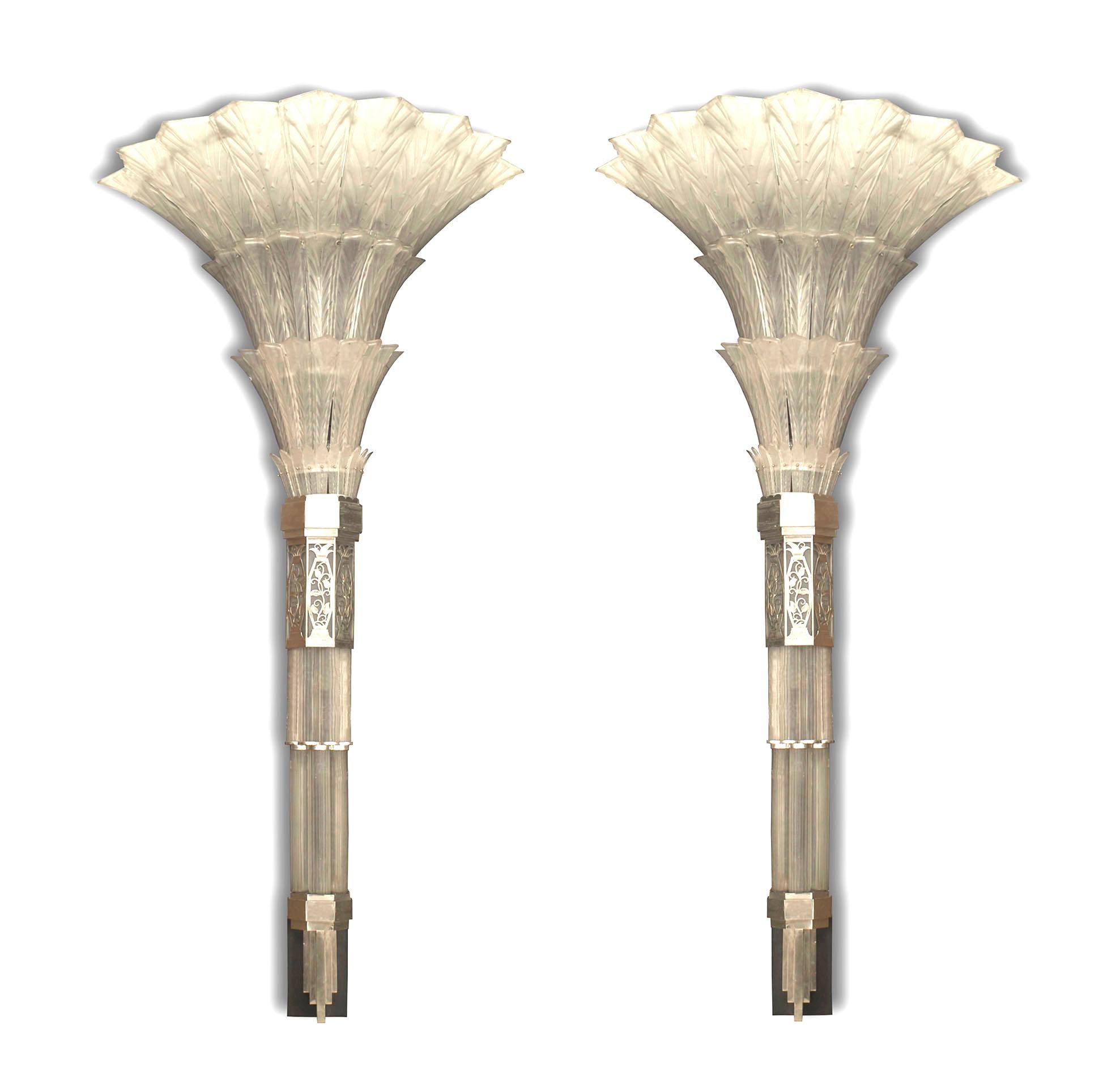 Pair of French Art Deco (1930s) monumental wall sconces with a geometric flared tiered glass panel upper section over a bottom finial beneath a band of chrome plated filigree trim (signed SABINO)
