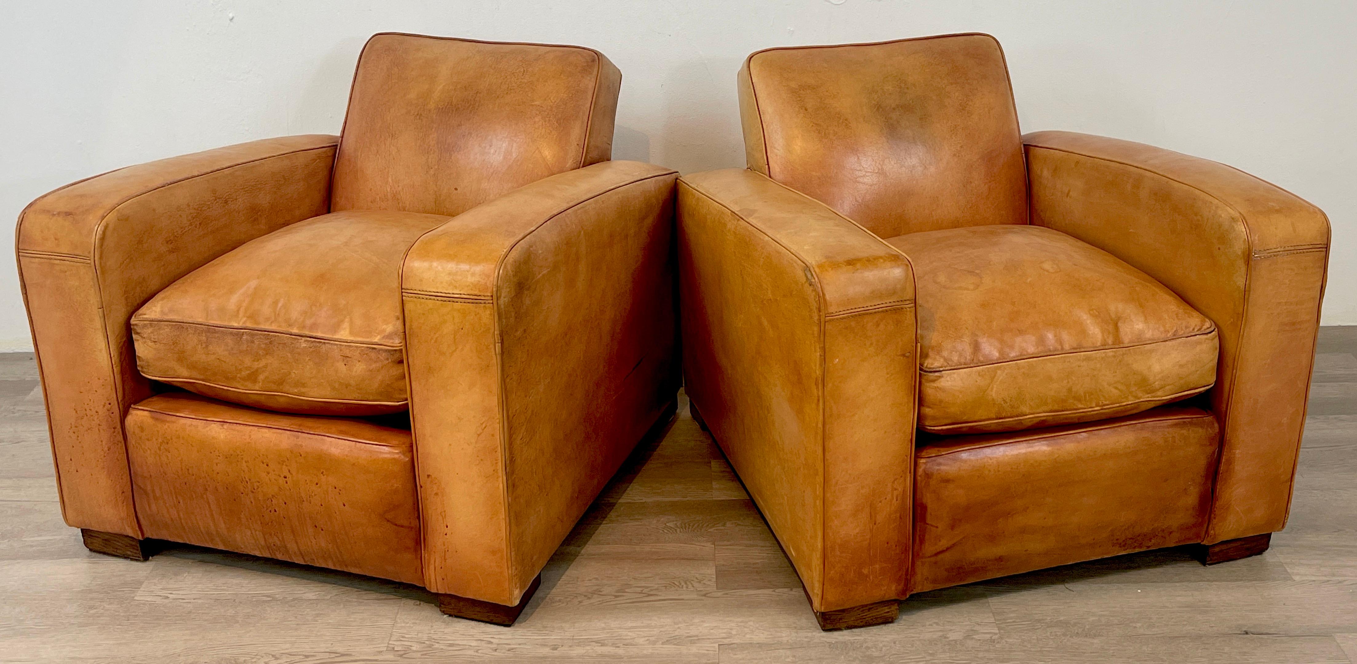 Pair of French Art Deco leather club chairs, beautifully distressed, structurally sound, comfortable. 
Each chair measures 31