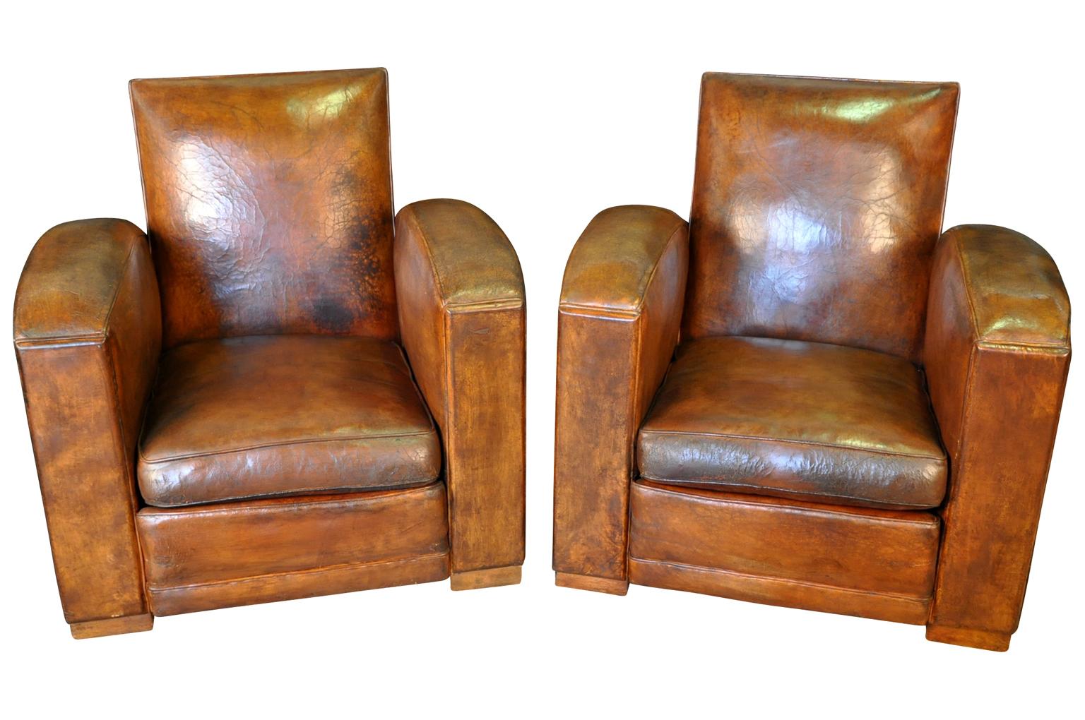 A terrific pair of French Art Deco club chairs in leather. Very sound and sturdy. Wonderful minimalists lines. Perfect for any living area, office or library.
