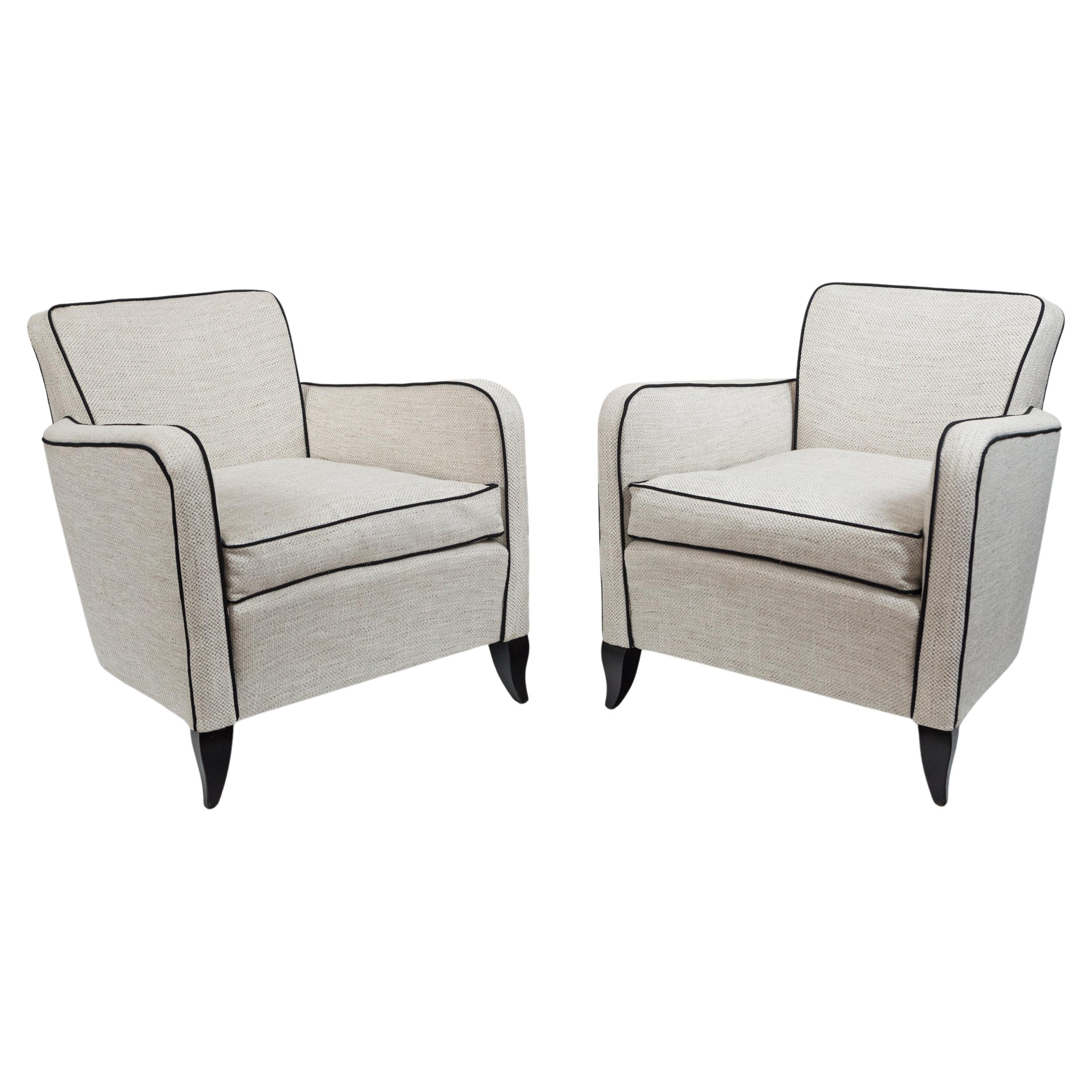 An elegant early pair of Art Deco club chairs in a slightly smaller scale shown with dark stained beech feet
Reupholstered in a thick creme cotton & chenille  linen weave with black piping
Note an extremely comfortable and supportive seat
Origin: