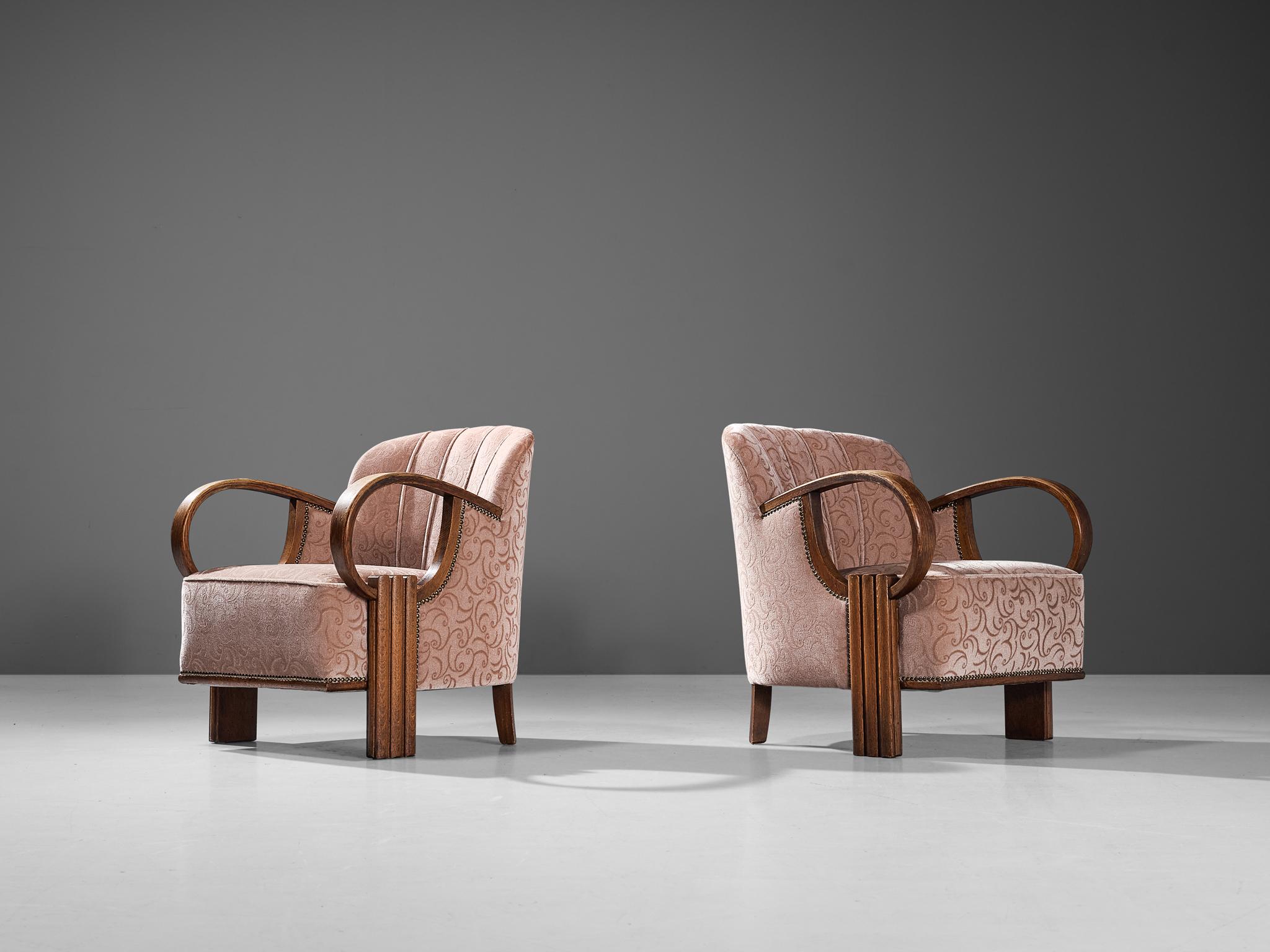 Pair of lounge chairs, oak, velvet, metal, France, 1930s

This charming pair of French lounge chairs are created in one of the most influential periods for the arts namely the Art Deco Movement. The armrests are curved in a hemispherical shape