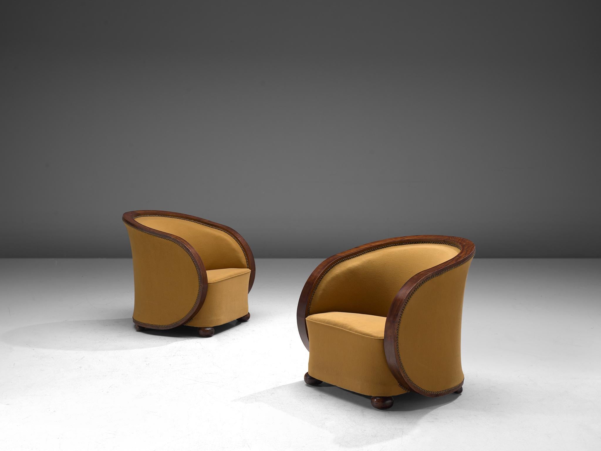 Pair of lounge chairs, wood and fabric, France, 1940s.

Beautifully Art Deco club chairs made from bentwood and fabric. The chairs have an elegant, almost theatrical appearance thanks to its round forms, emphasized by the wooden curved slat that is