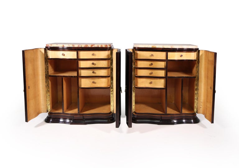 A pair of French Art Deco side cabinets with serpentine fronts in macassar ebony with marble onyx tops and chestnut lined. The cabinets have been restored where necessary and fully polished, the tops have been broken repaired in there lives good
