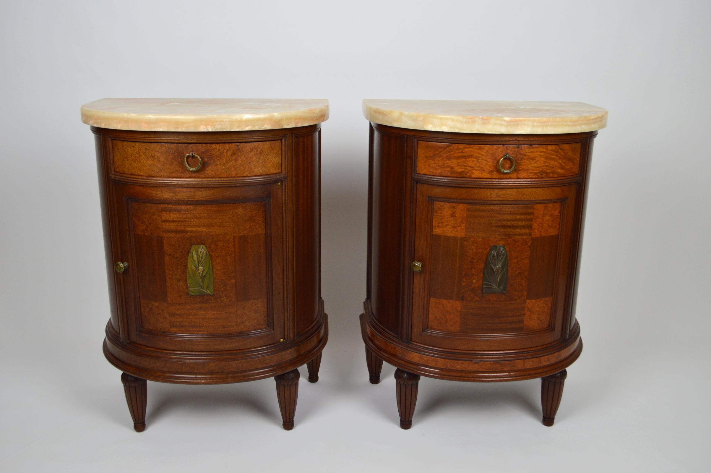 - Pair of bedside tables 
- French luxury production, first era of Art Deco, 1920s 
- Solid mahogany and veneer 
- Bronze handles, door knobs, designs on doors 
- Marble trays are thick and heavy: weigh 15-20 kg each 
- Marble thickness: 3