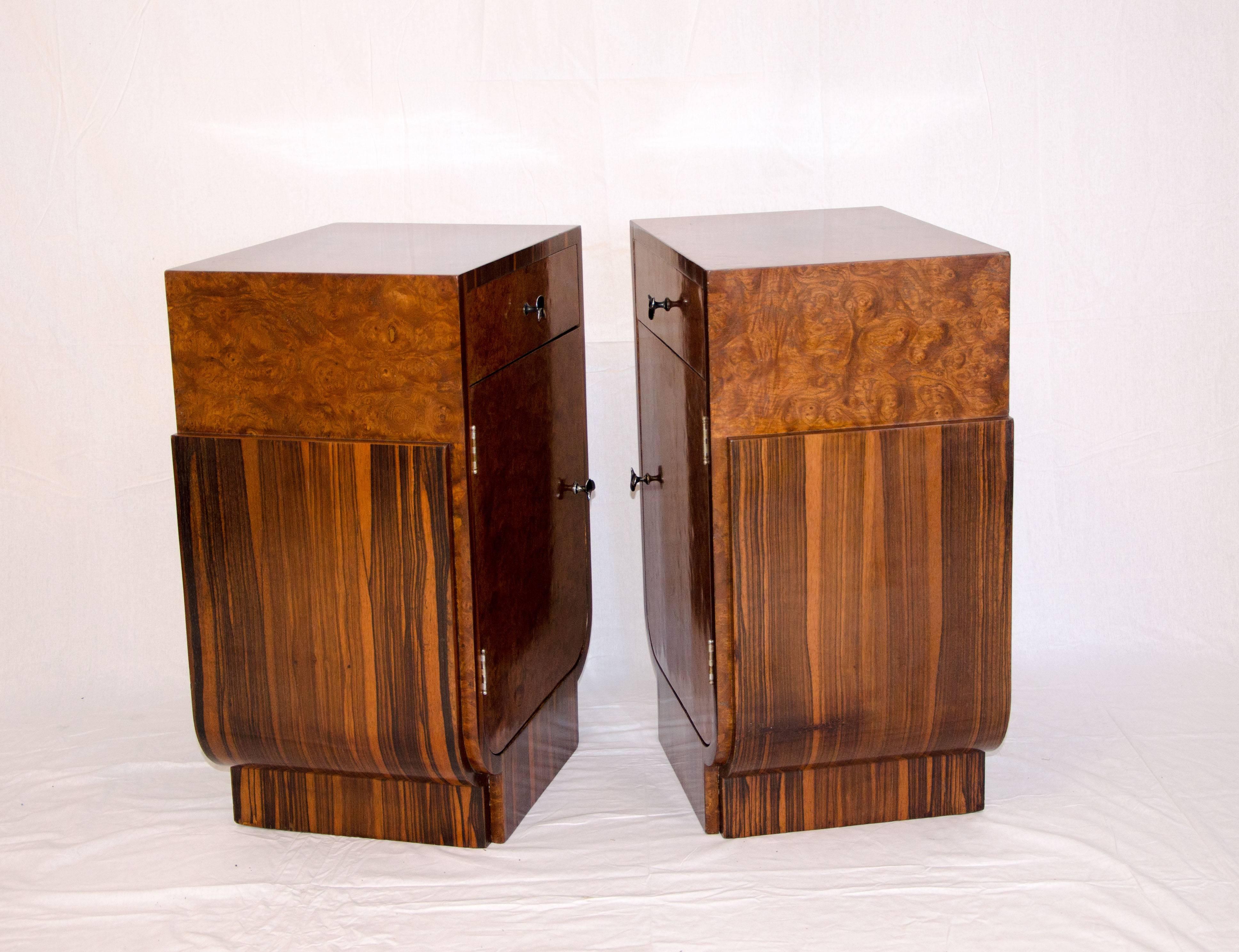 Tall pair of Macassar ebony and Carpathian elm burl French Art Deco nightstands with one drawer and lots of interior space including a removable shelf. There is a right and left-hand orientated nightstand. The design is accented by a 