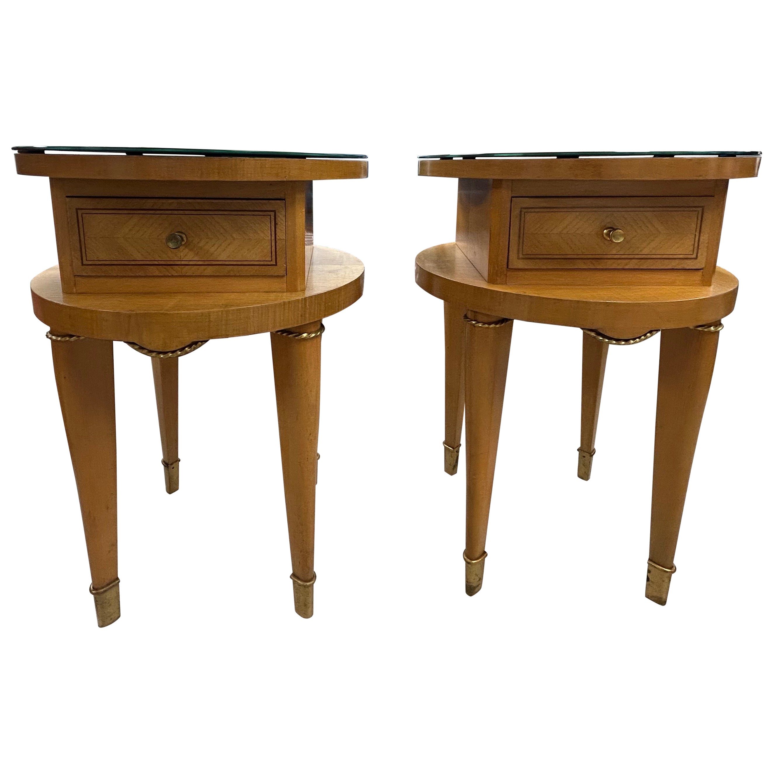 Pair Of French Art Deco Nightstands.
Offered is a unusual pair of French Art Deco nightstands or side tables each with a single drawer, black glass tops and accented with bronze hardware. Our small French chests are versatile enough to use in a