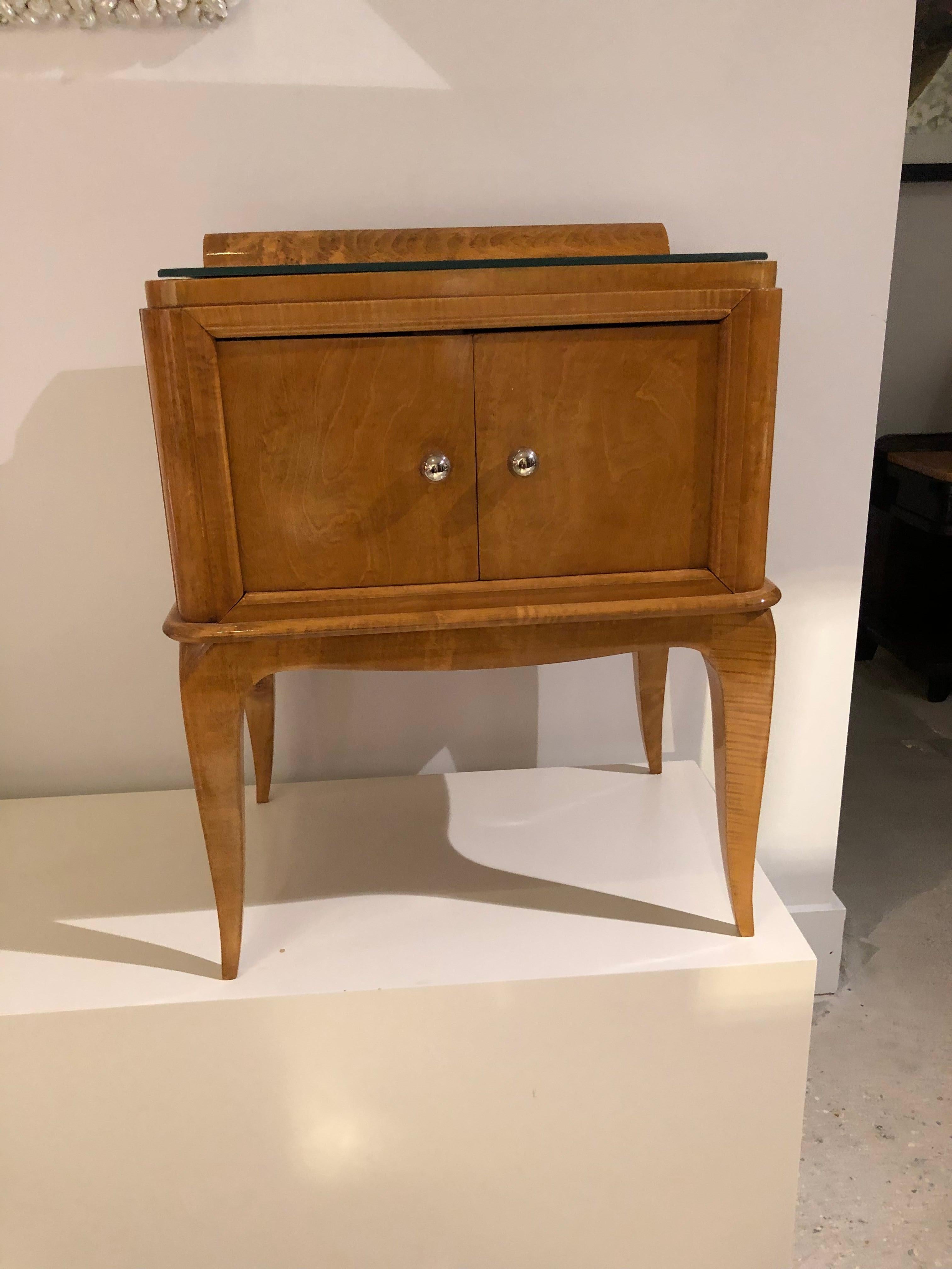 A pair of French Art Deco sycamore nightstands with rose mirrored tops, nickel-plated hardware and two front doors.