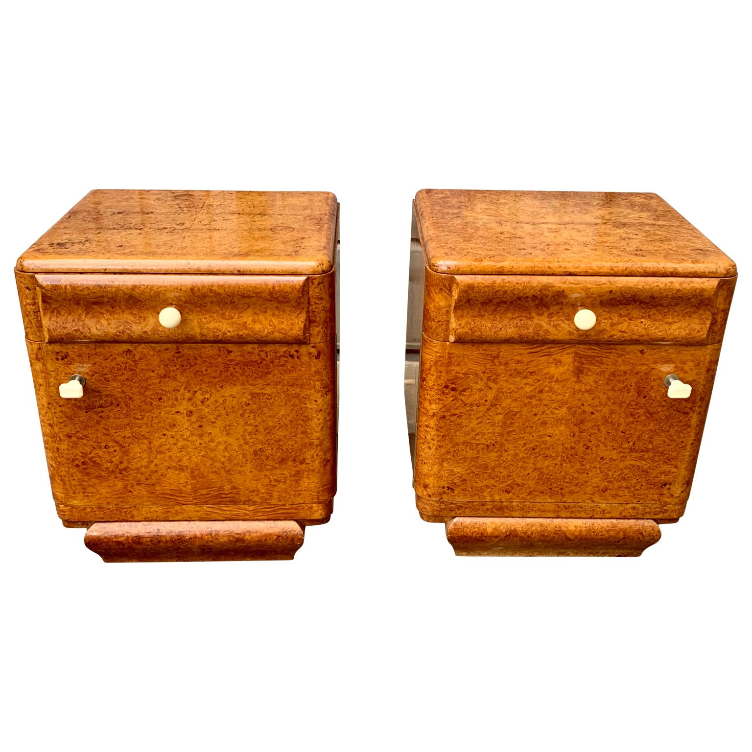 A charming pair of French nightstands or small night tables in walnut burl veneer wood and original white resin hardware.
This set is a honest pair, meaning that the set has left and right facing doors the cabinets. They were recently bought in