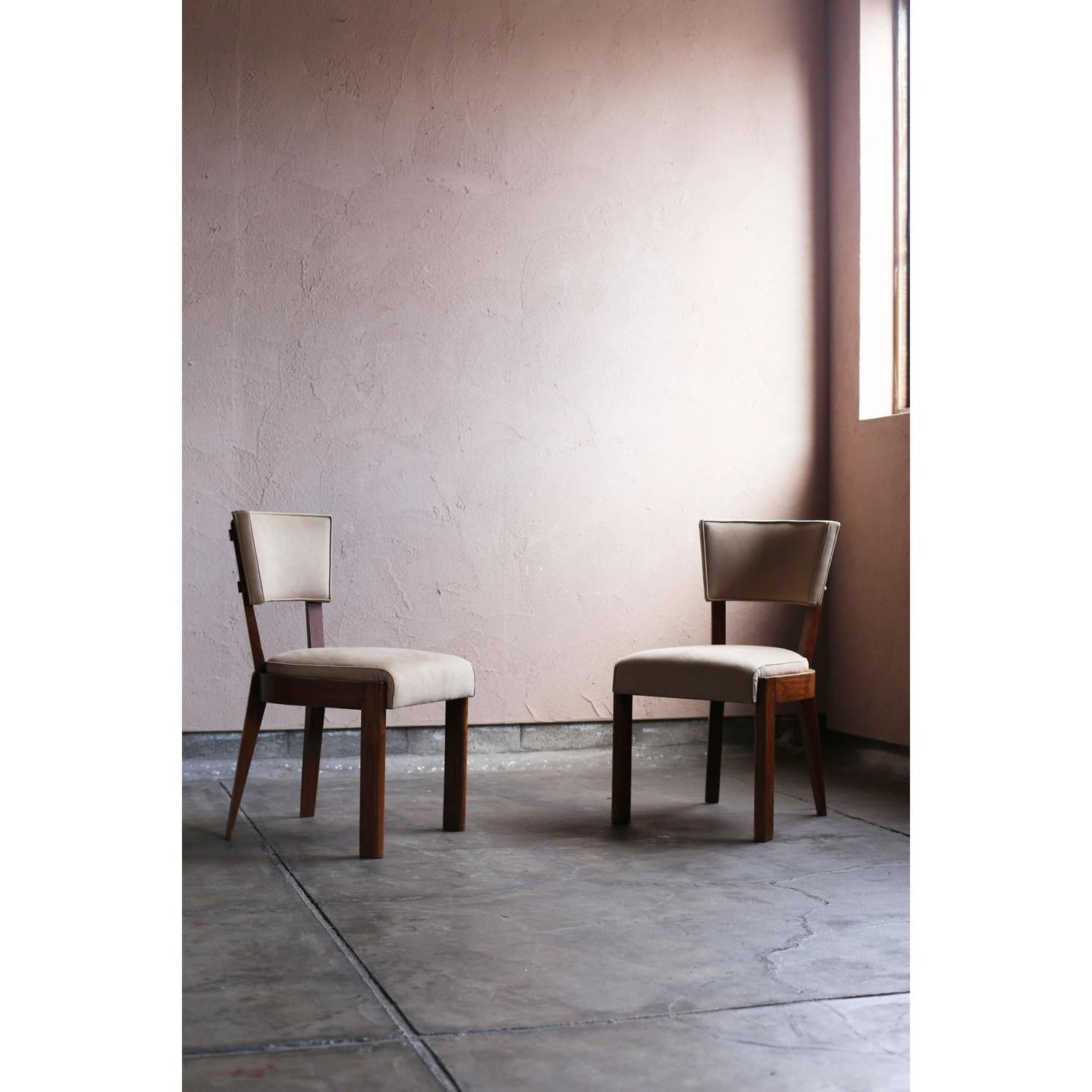 This dining chair was designed around 1930 by French designer Charles Dudouyt. It is an Art Deco design from a period just before the mid-century period, and while it still retains some of its ornamentation, it is not overly ornate like previous