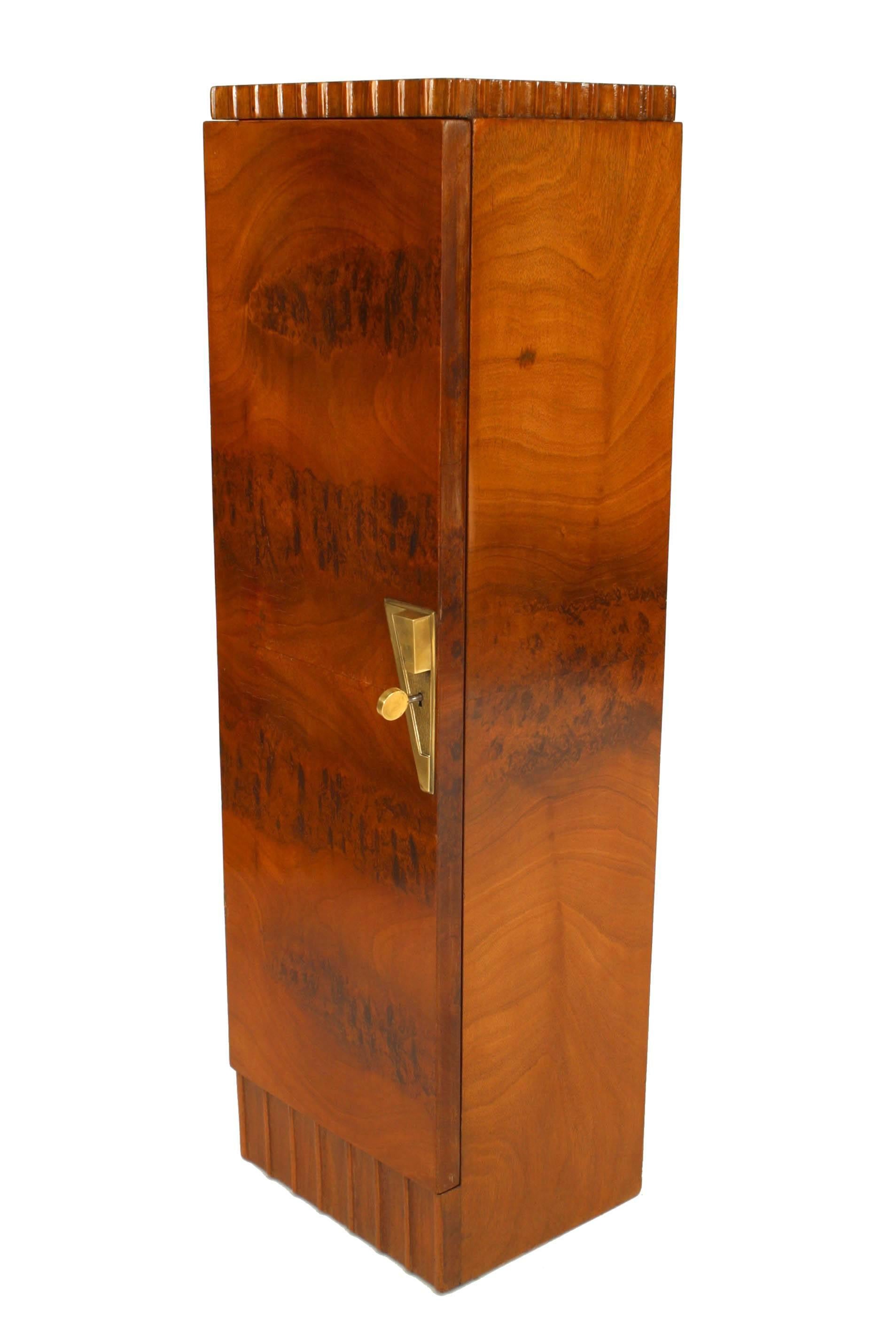 Pair of French Art Deco mahogany veneer pedestals/cabinets with a fluted top & bottom edge and a front door with a bronze geometric form keyplate. Finished on back. (att: Roger Bal)

