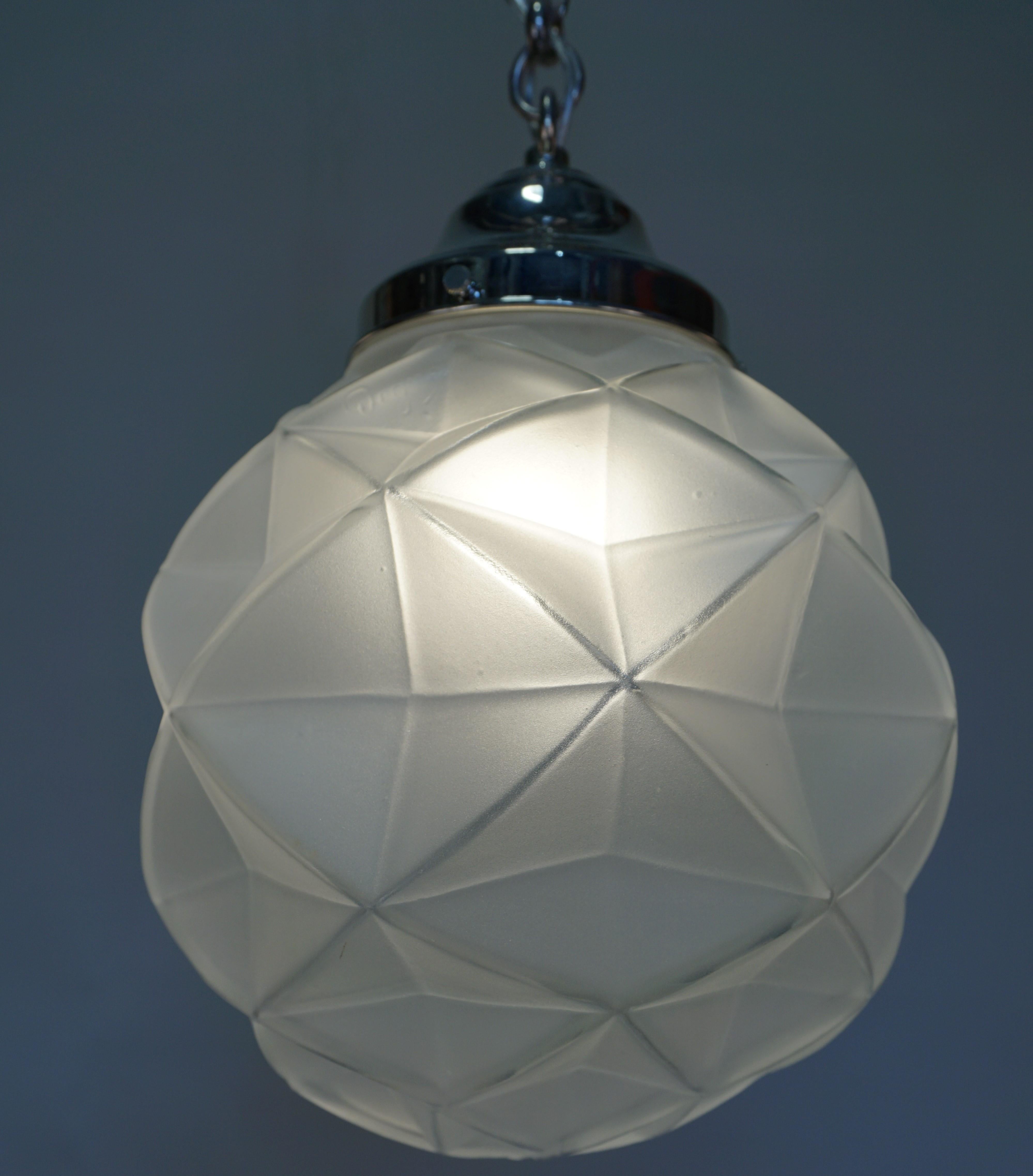 Pair of 1920s geometric glass with nickel hardware pendant chandelier.