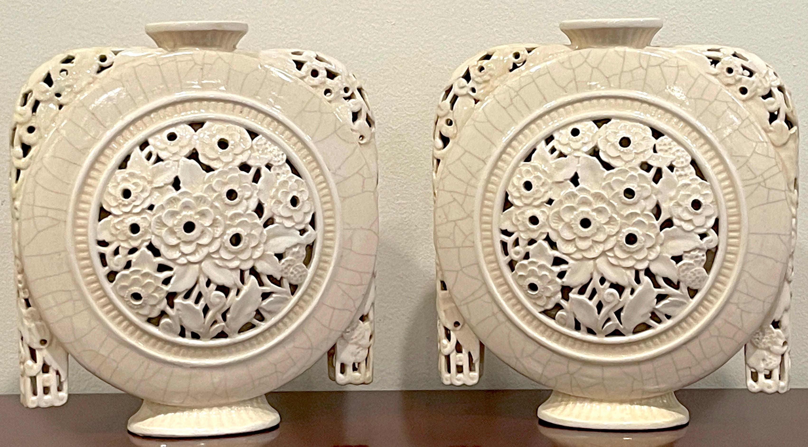 Pair of French Art Deco pierced moon flask vases by, Henri Chaumeil
France, Circa 1920-1930s
A iconic period example of the Art Deco style, made by renowned French potter Henri Chaumeil. Each vase of moon flask form with pierced draped handles,