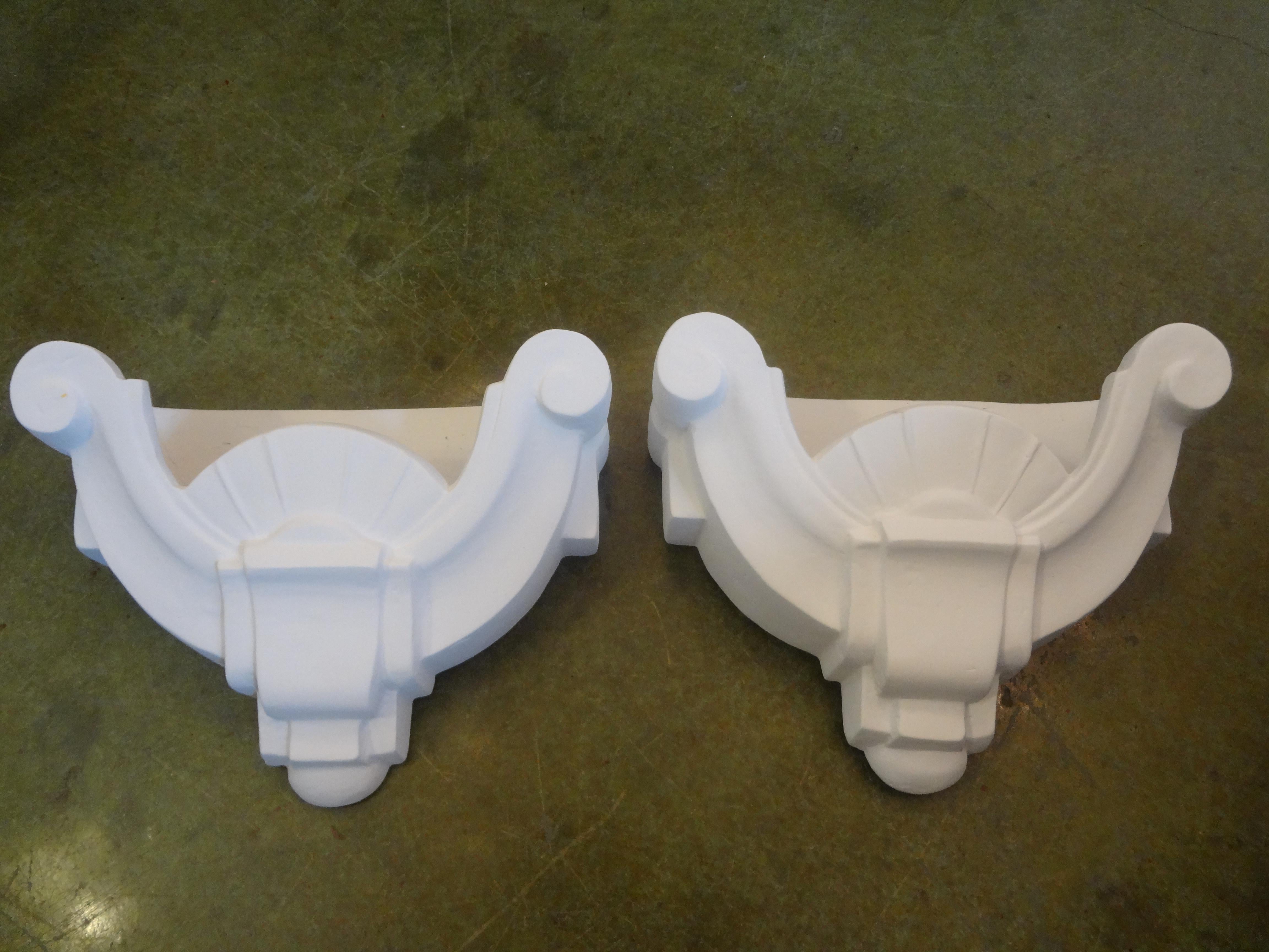 Stunning pair of French Art Deco plaster sconces after Serge Roche. These fabulous plaster sconces have an Art Deco geometric style and have been newly wired to U.S. specifications.