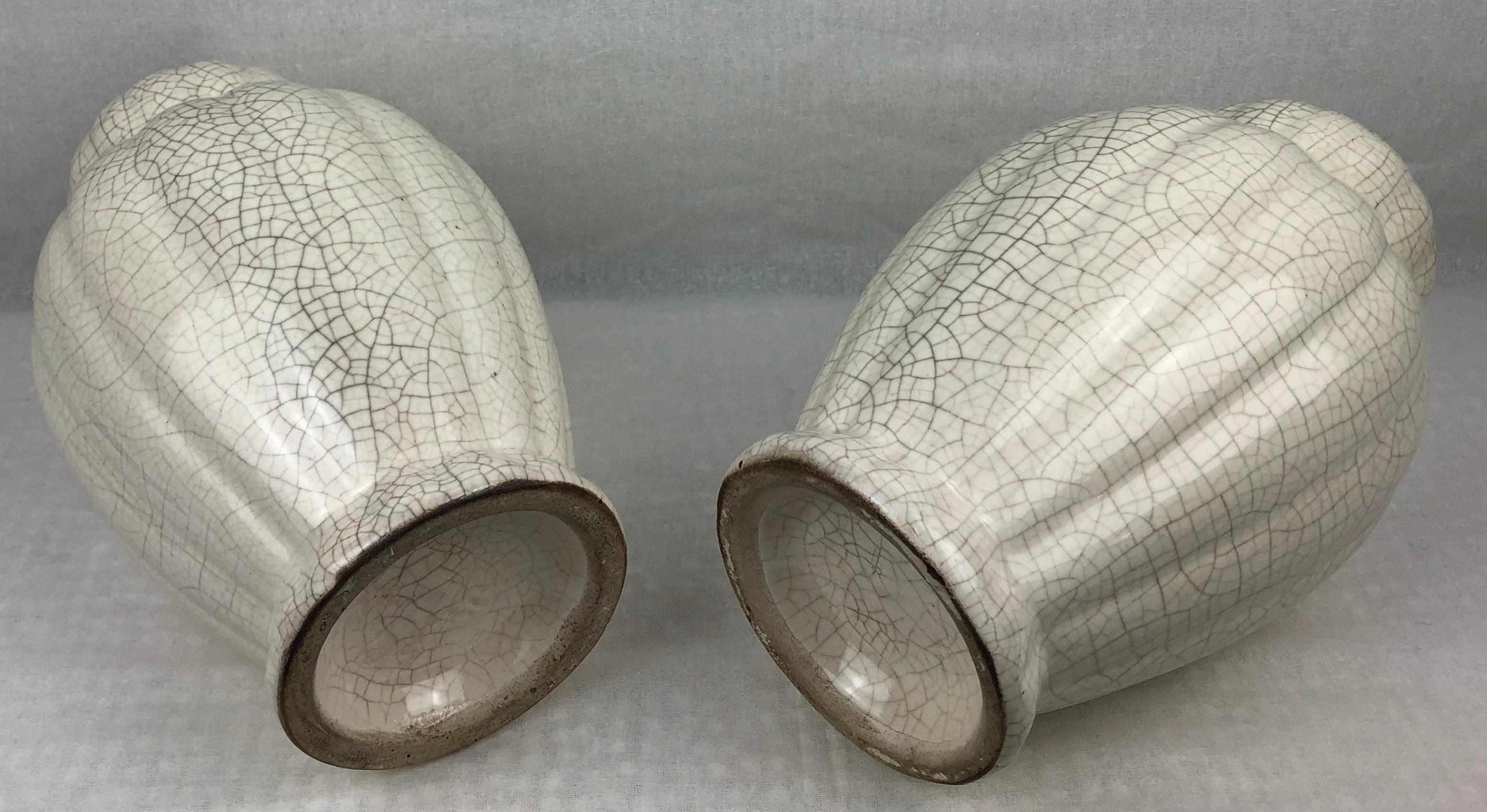 Stunning pair of Art Deco ceramic vases by Saint Clement with white crackle glaze finish. The crackle clear glaze was a popular technique for animal and figural statues as well as decorative vases during the Art Deco period in France. Most of those