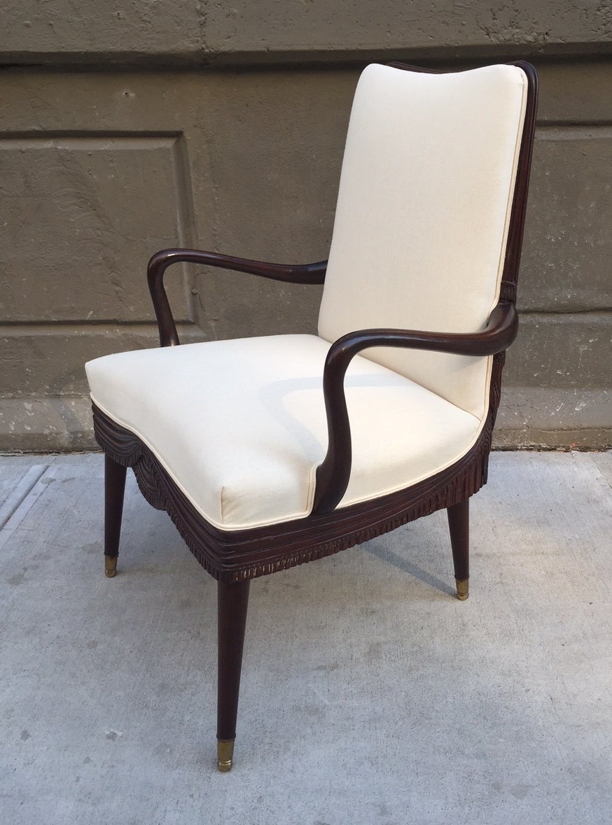 Chairs are newly upholstered in a linen blend fabric. The chairs have mahogany frames with brass feet.
